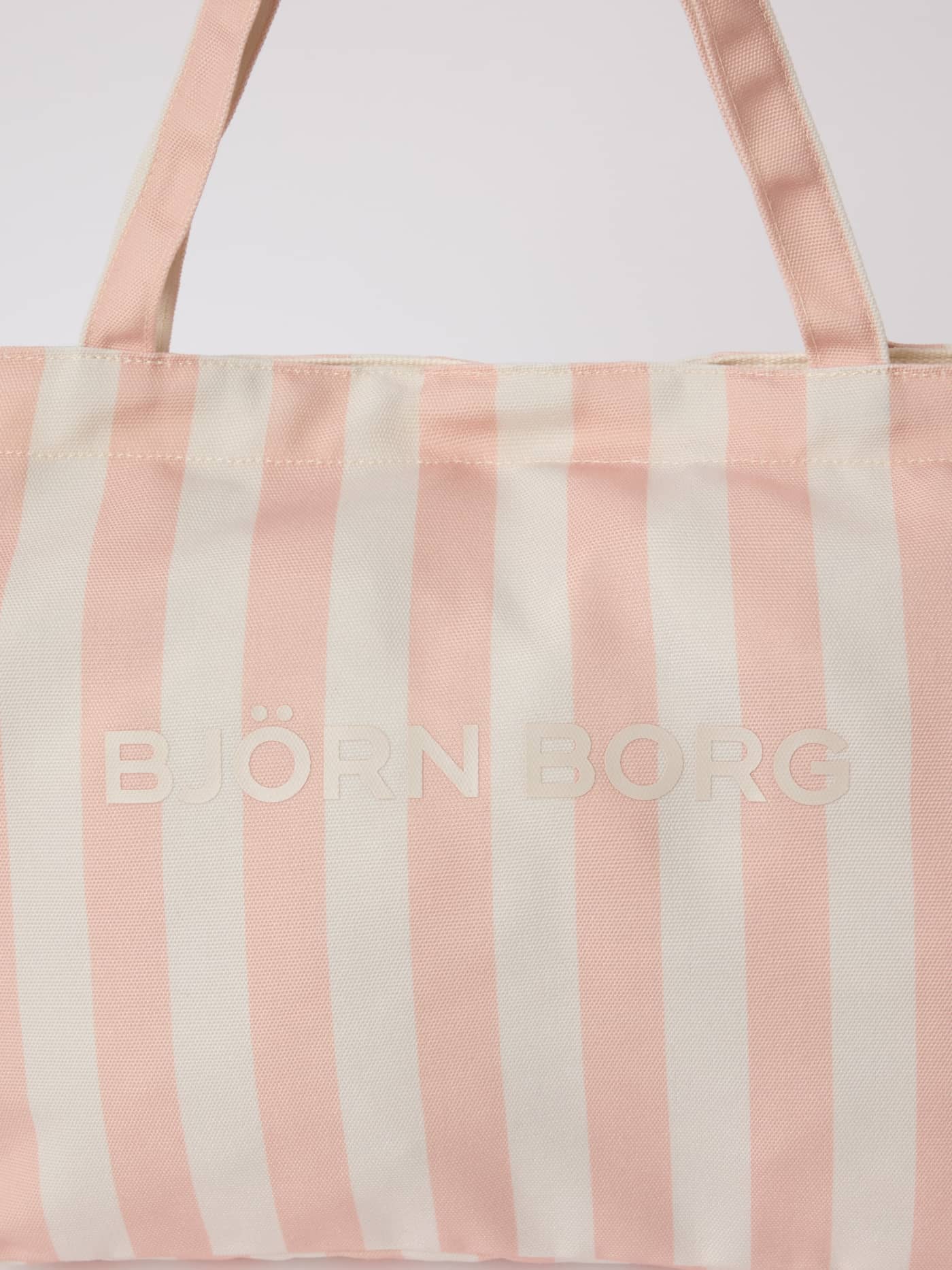 Close-up of the striped Borg Beach Tote M - 27L in Rose Cloud (Pink) with an off-white logo on recycled polyester. - Image 3