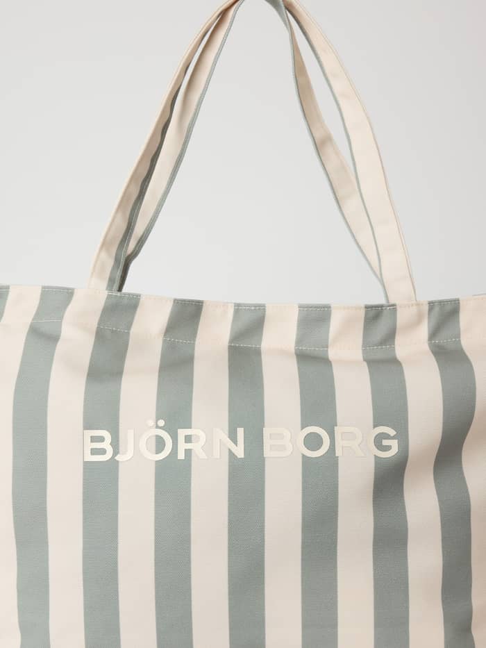 Detailed close-up of the recycled Borg Beach Tote M - 27L in Slate Gray (Green) with vertical stripes and a cream logo.