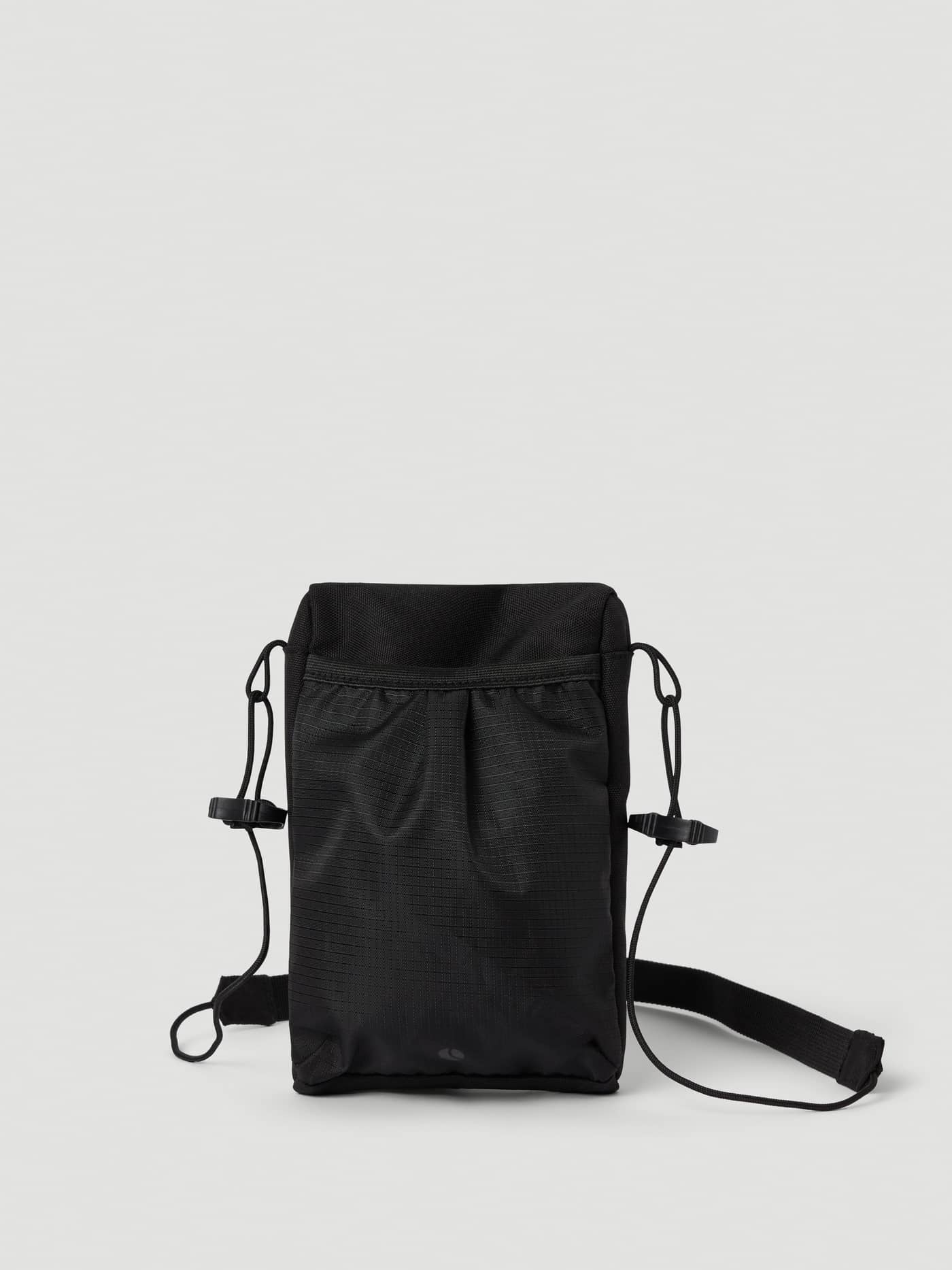 Back view of the Borg Crossover Bag S in Black Beauty (Black) featuring a mesh pocket and adjustable strap. - Image 2