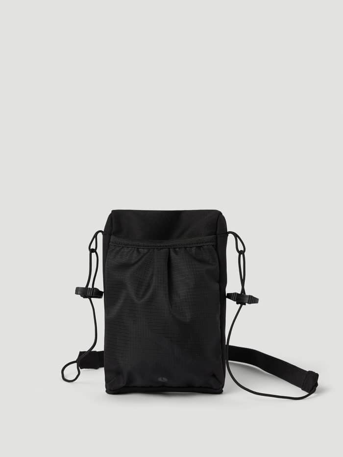 Back view of the Borg Crossover Bag S in Black Beauty (Black) featuring a mesh pocket and adjustable strap. - Image 2