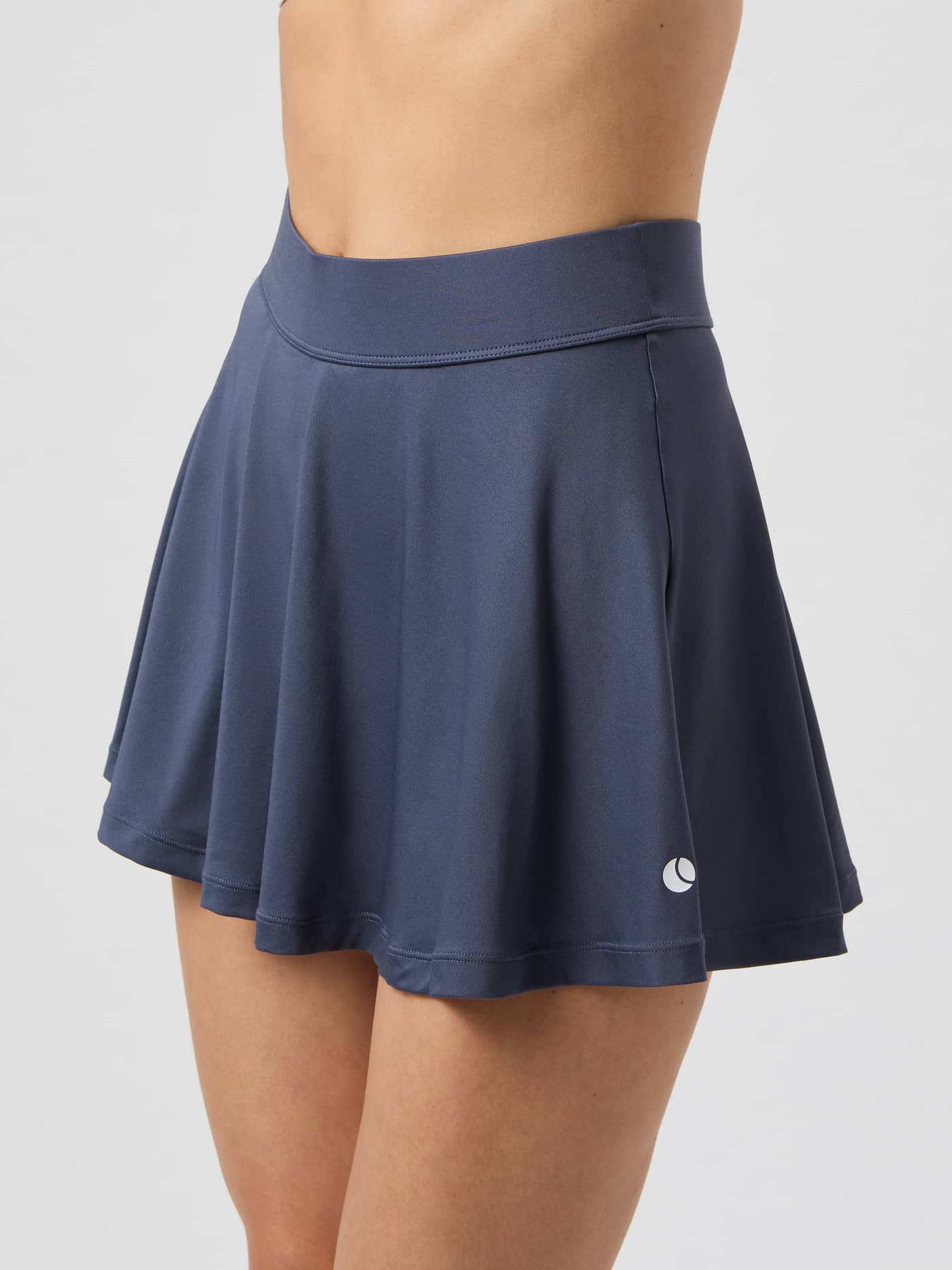 Close-up side view of a model wearing the Björn Borg Ace Jersey Skirt in Odyssey Gray. - Image 4