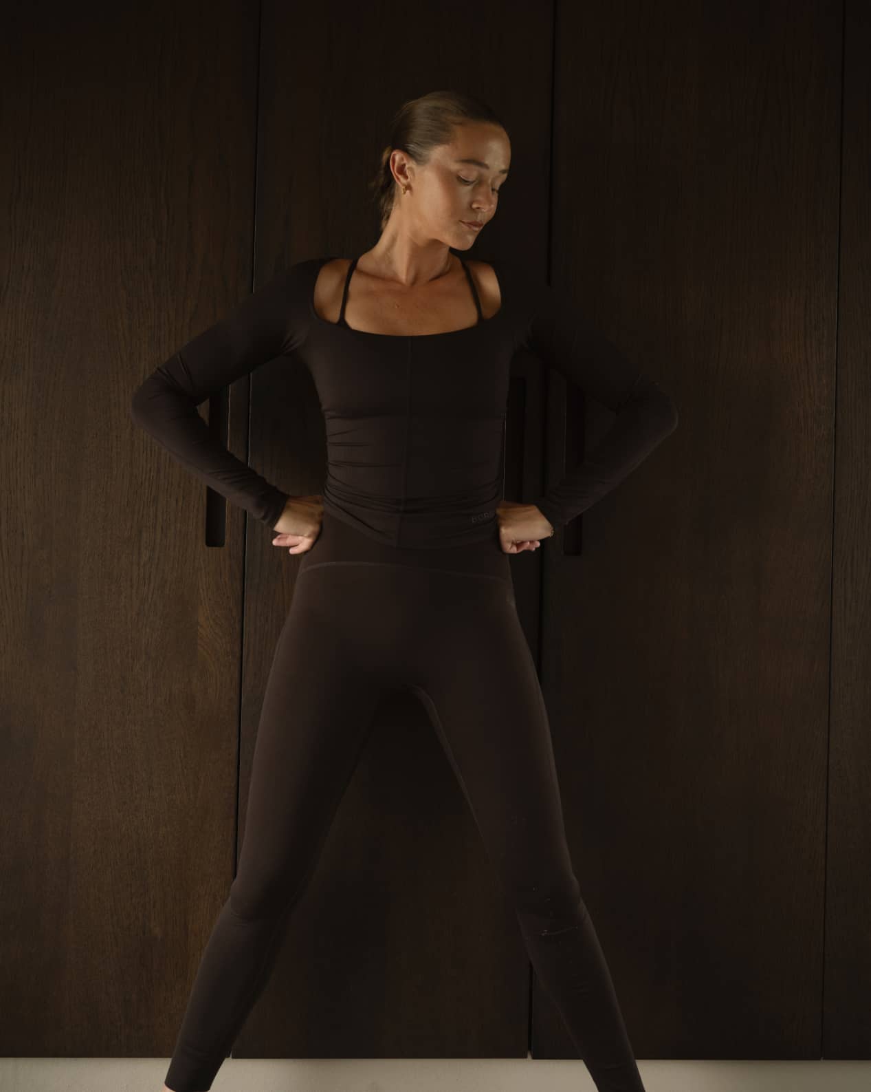 Front view of a woman wearing the Björn Borg Studio Ballerina Long Sleeve in Molé (Brown), a stylish slim-fit training top. - Image 2