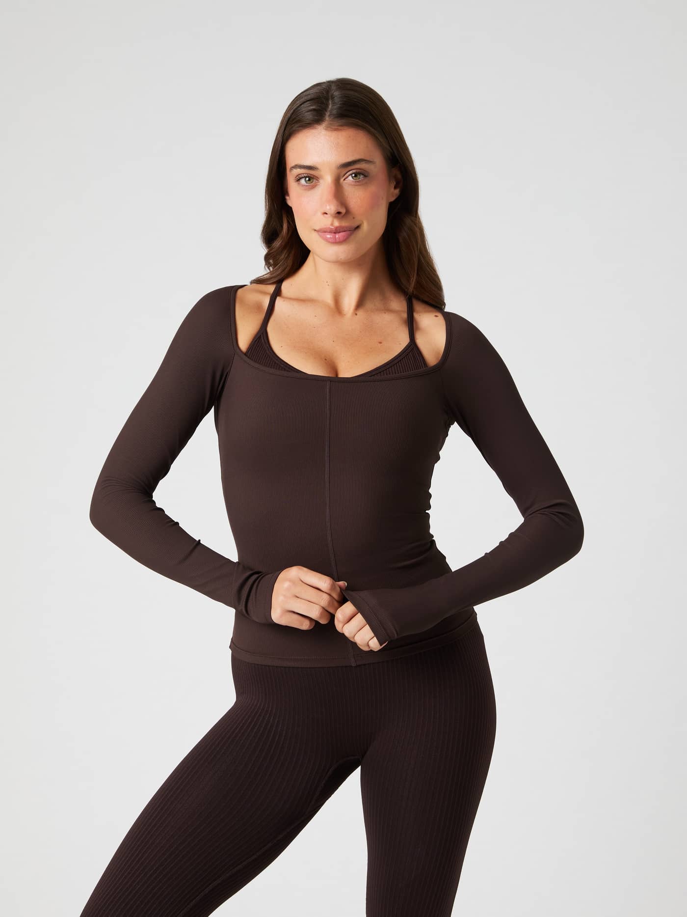Front view of a model wearing the slim-fit Björn Borg Studio Ballerina Long Sleeve in Molé (Brown) for training. - Image 1