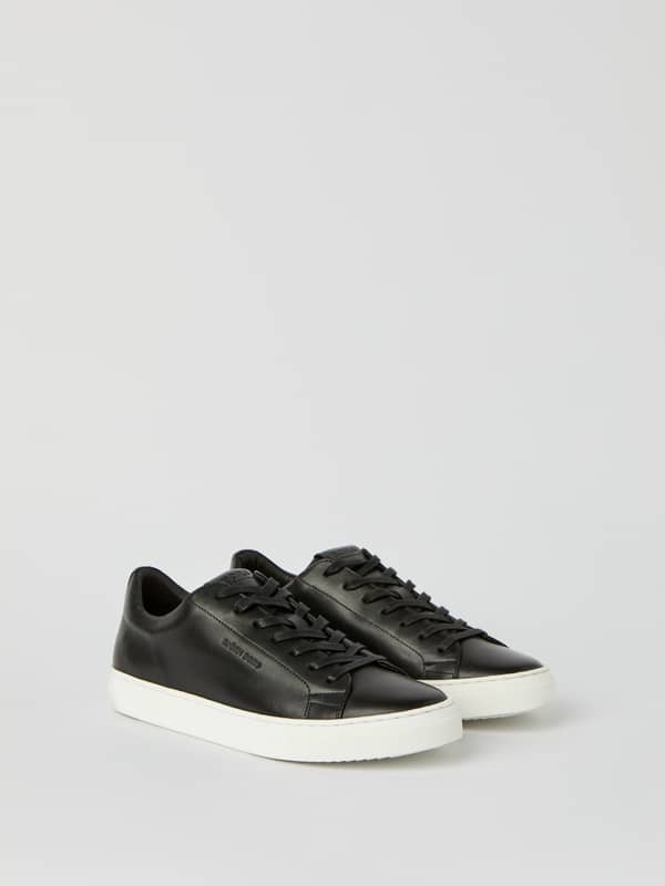 Baskets Men’s Classic Leather sneakers en cuir de vache noir et semelle blanche pour un style tennis.