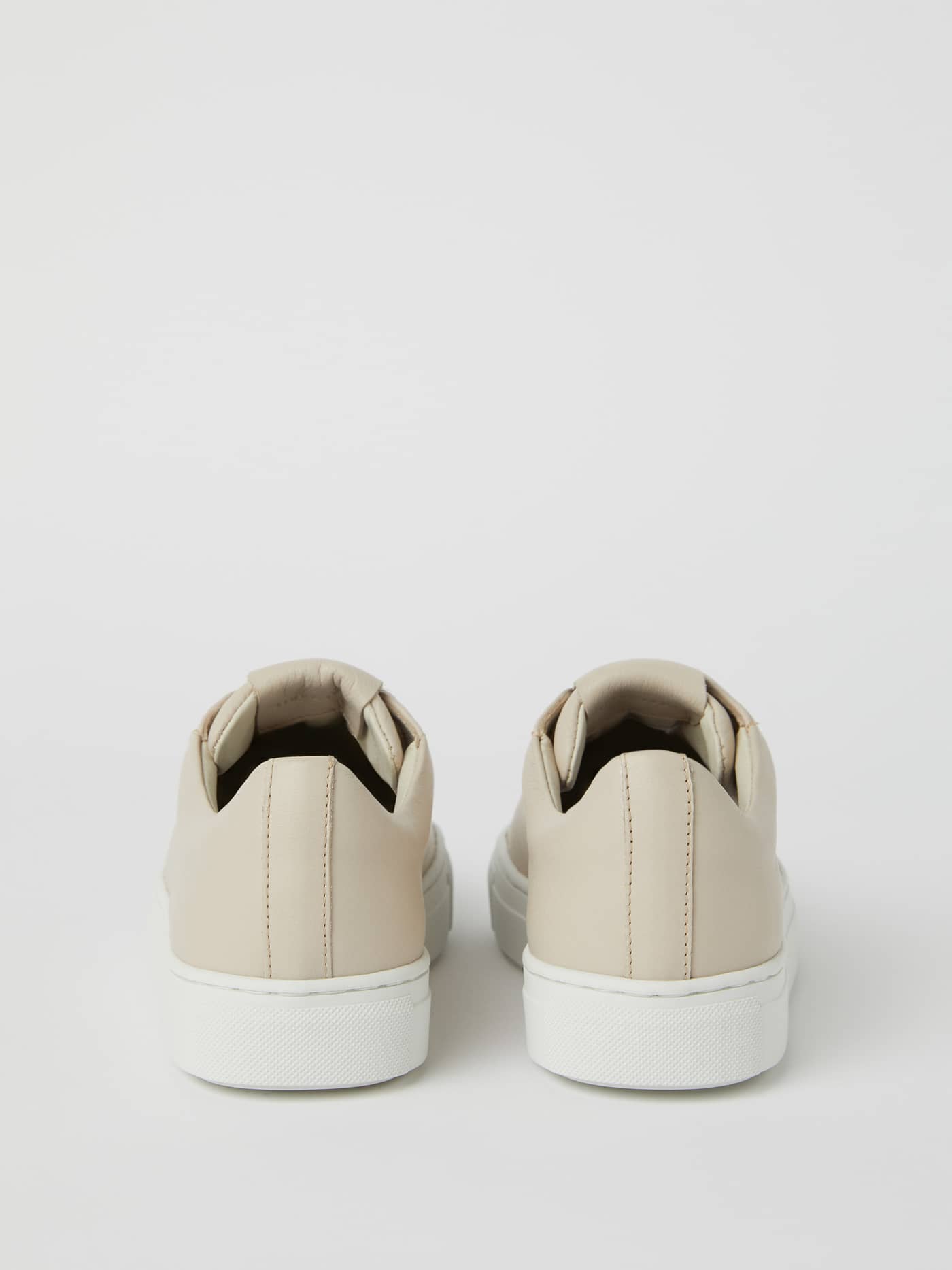 Back view of the beige Womens Leather sneakers Sl100, featuring a premium leather finish and stylish white rubber sole. - Image 2