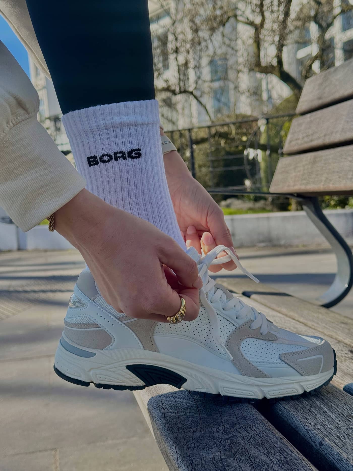 Close-up of the white Women's Alley Sneakers for running, featuring a supportive fit and a black BORG logo on the sock. - Image 5