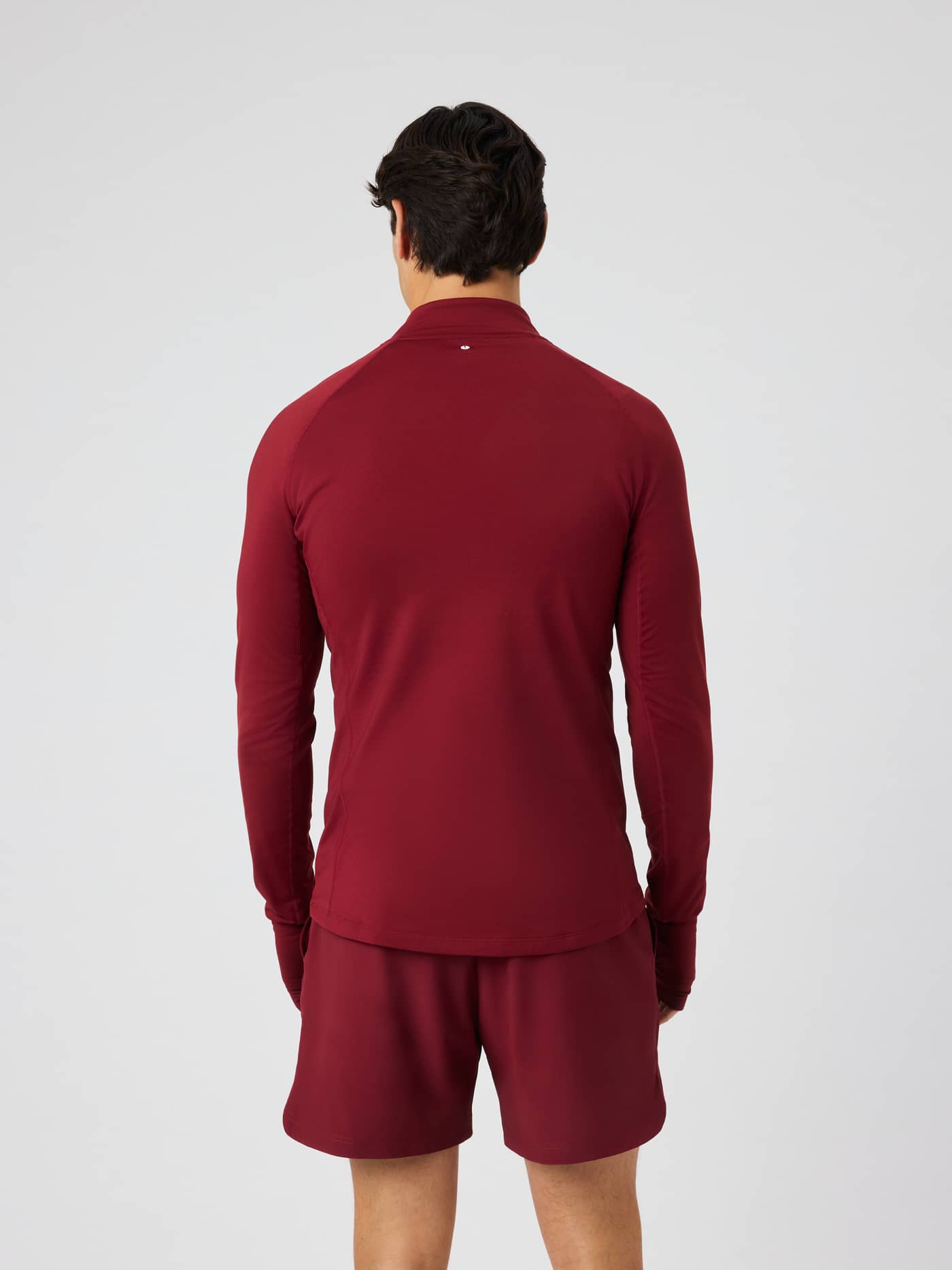 Back view of the Borg Midlayer Half Zip in Cabernet (Burgundy) for training, showing raglan sleeves and side panels. - Image 3