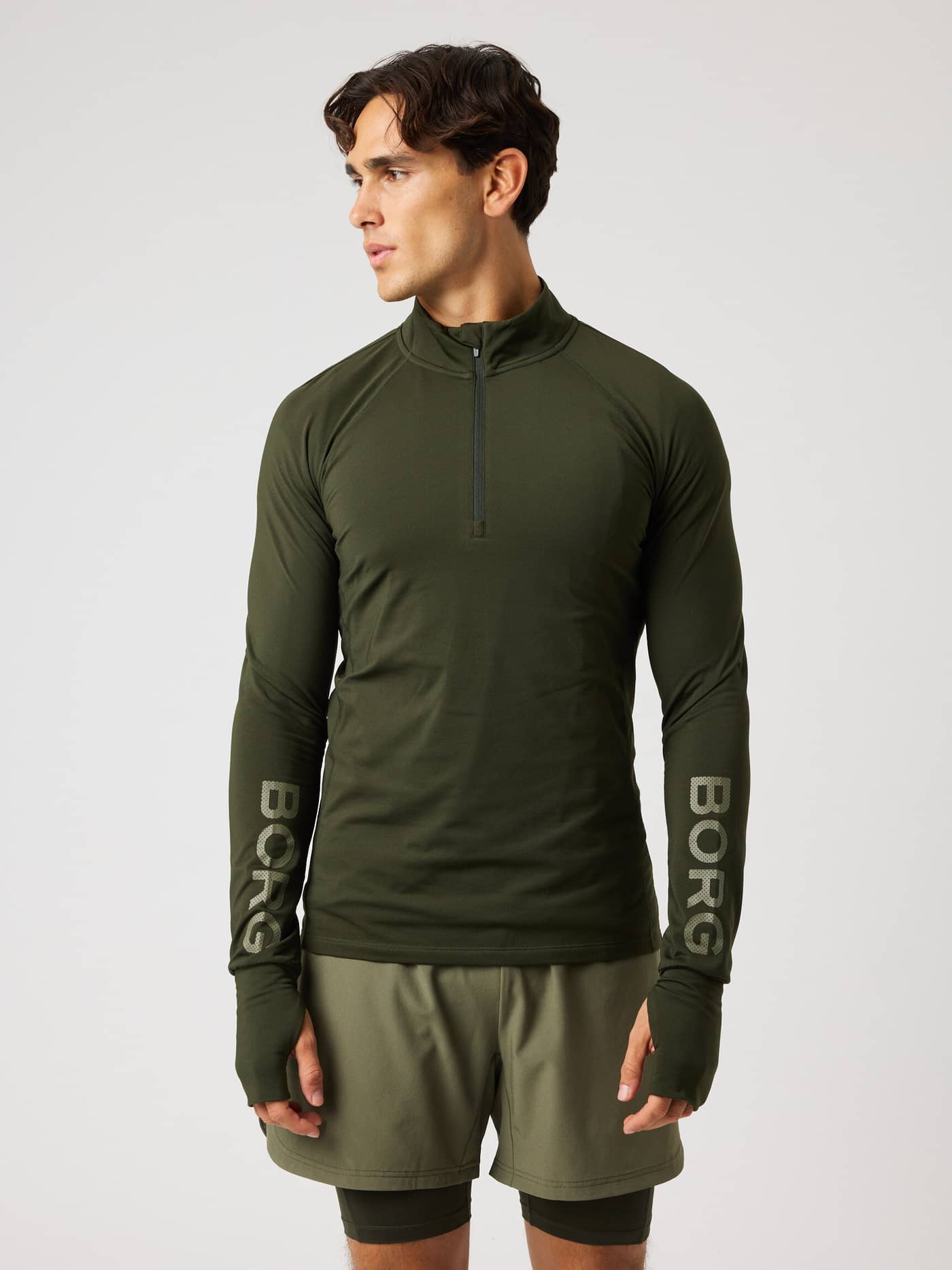 Front view of the Borg Midlayer Half Zip in Rosin (Green) with grey logos and thumbholes for performance training. - Image 2