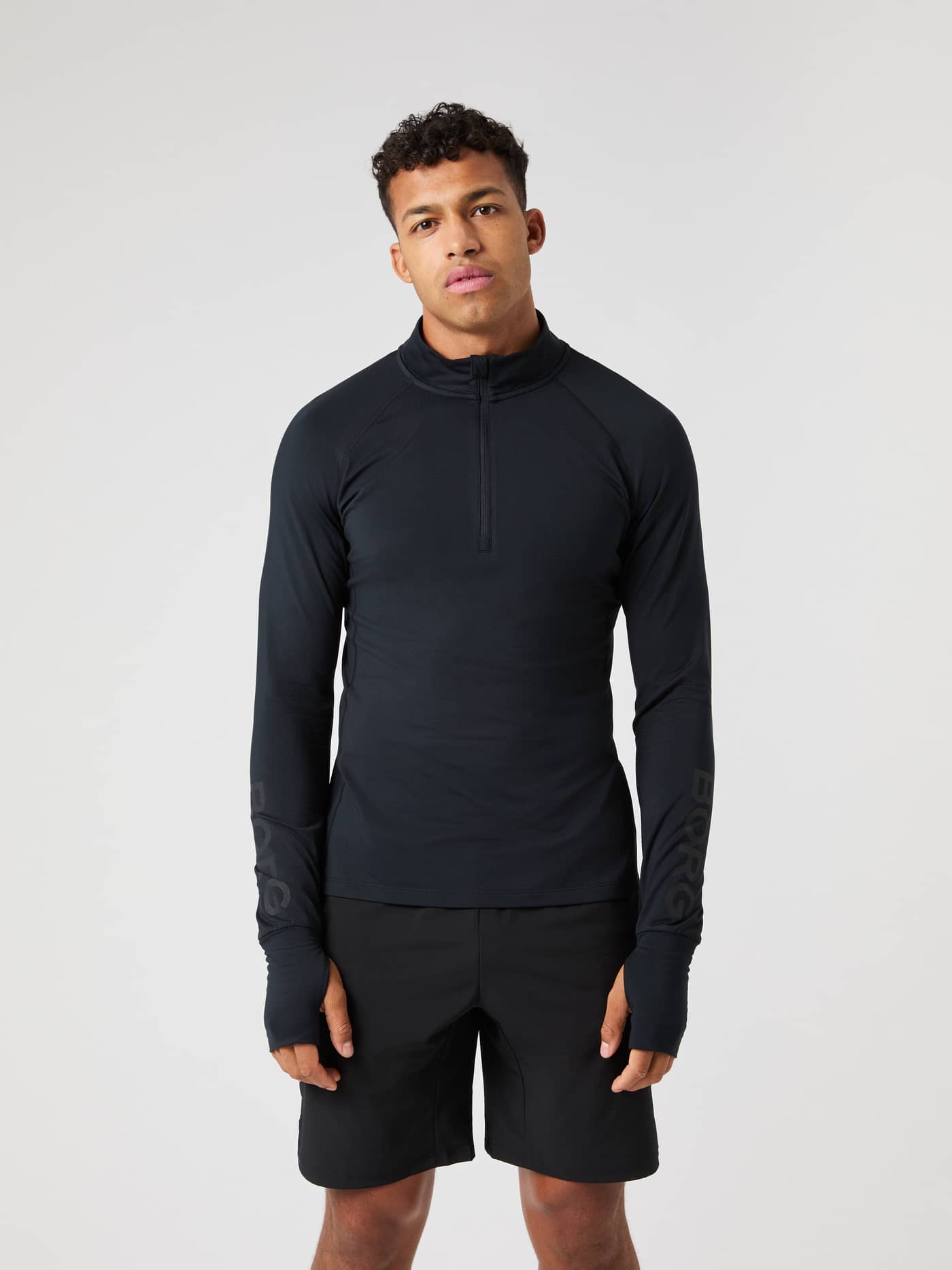 Front view of a male model wearing the black Borg Midlayer Half Zip. - Image 2