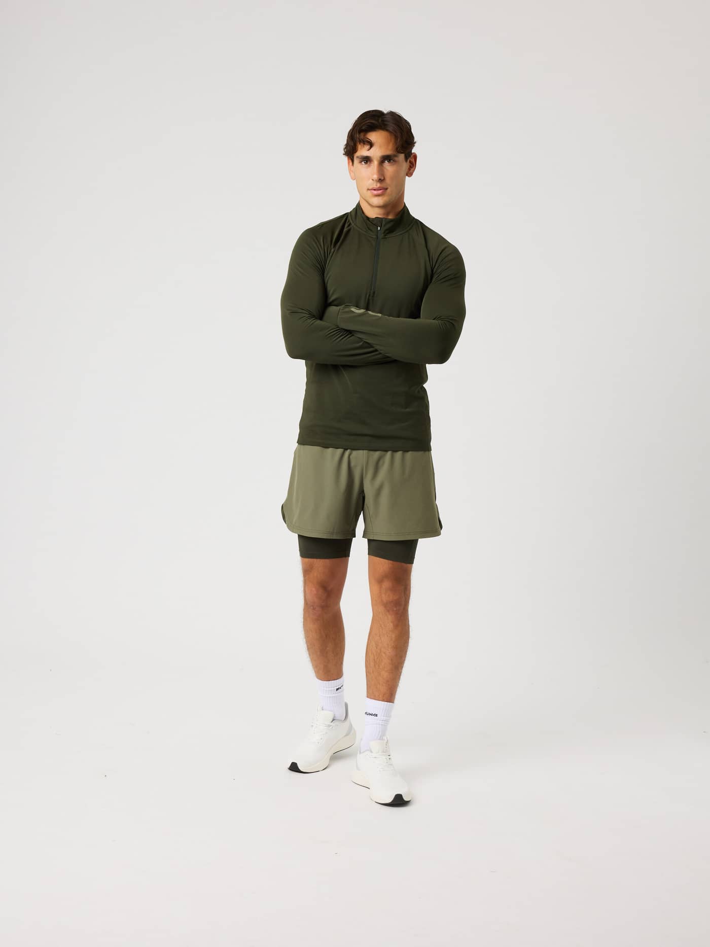 Full-body front view of a man wearing the Borg Midlayer Half Zip in Rosin (Green) for premium training performance. - Image 4