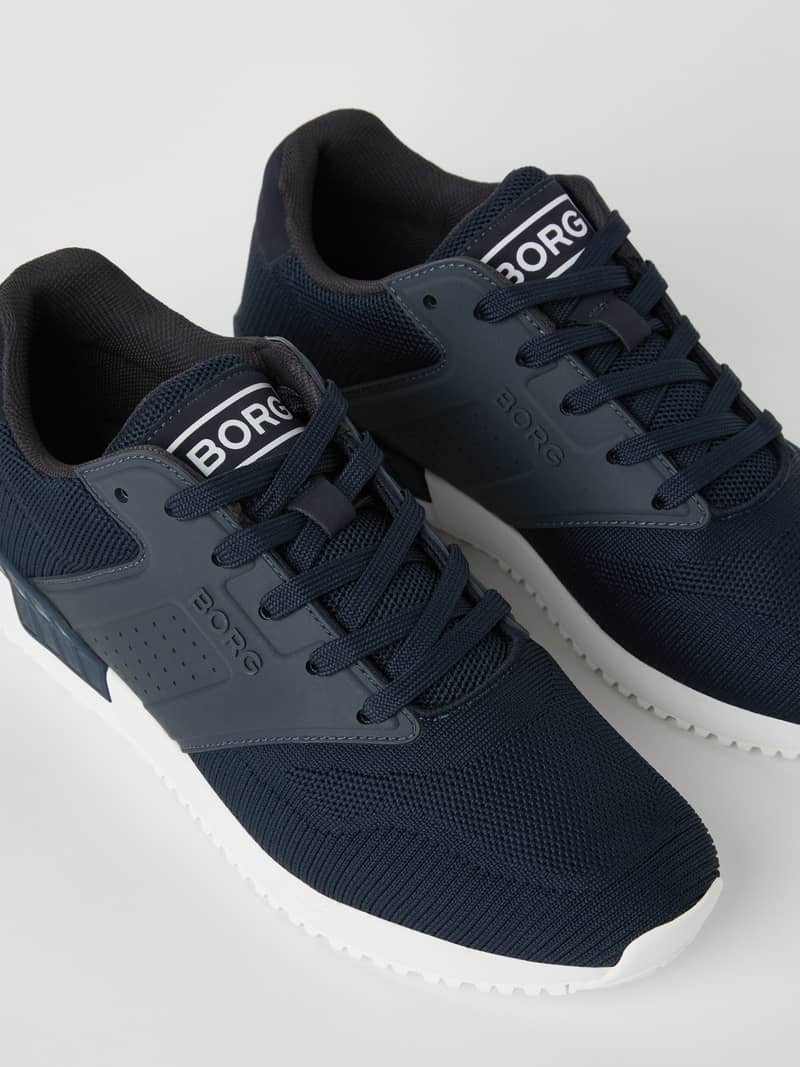 Navy Björn Borg Men’s sneakers R140 Knit for running, featuring a breathable knitted upper and white logo details.