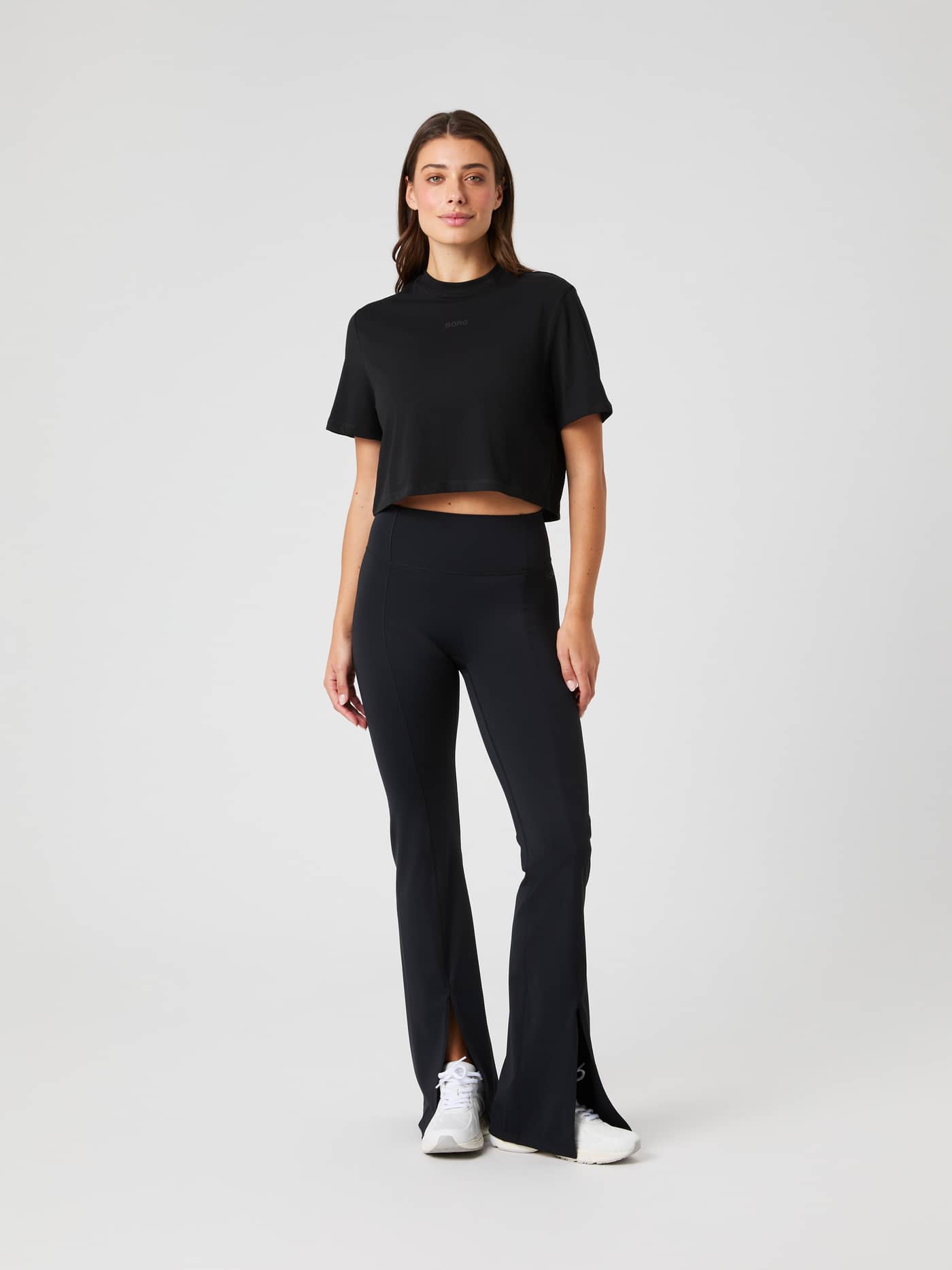 Full-body front view of a model wearing the Studio Oversized Cropped T-Shirt in Black Beauty (Black) for training. - Image 3