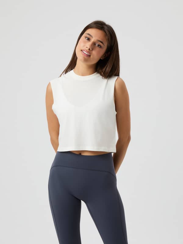 Front view of the Borg Cropped Tank Top in Cannoli Cream (White), a loose-fitting training top for women.