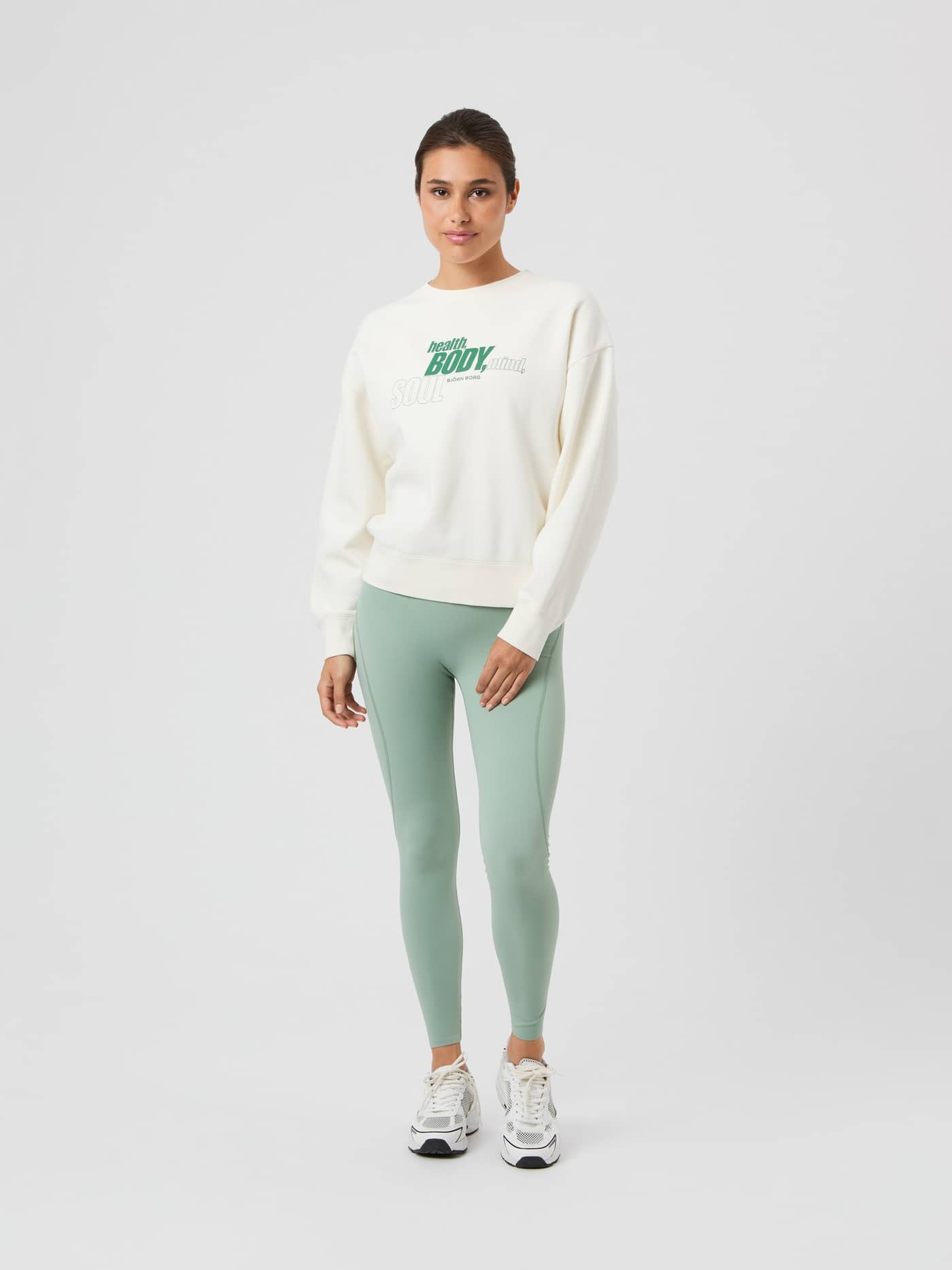 Full-body front view of a woman in the oversized Borg Boyfriend Sweatshirt in Cannoli Cream (White) with a graphic print. - Image 3