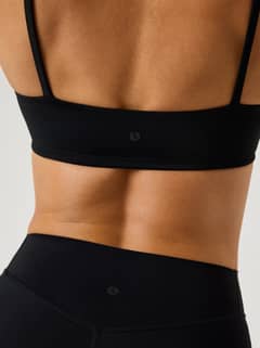 Close-up back view of the black Alice Stenlöf Soft Bra, featuring thin straps, a tonal logo and flexible fit for training. - Image 4