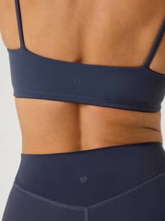 Achteraanzicht van de Alice Stenlöf Soft Bra in Odyssey Gray (Marineblauw) voor training met een tonaal logo en dunne bandjes - Image 4