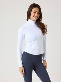 Front view of a model wearing the slim-fit Alice Stenlöf Soft Zip Midlayer in Brilliant White (White) for training. - Image 8
