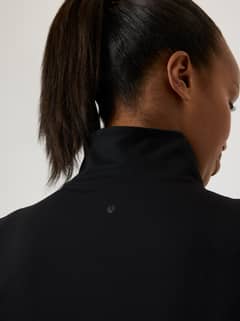 Back view of the training Alice Stenlöf Soft Zip Midlayer in Black Beauty (Black) featuring a tonal logo on the neck. - Image 9