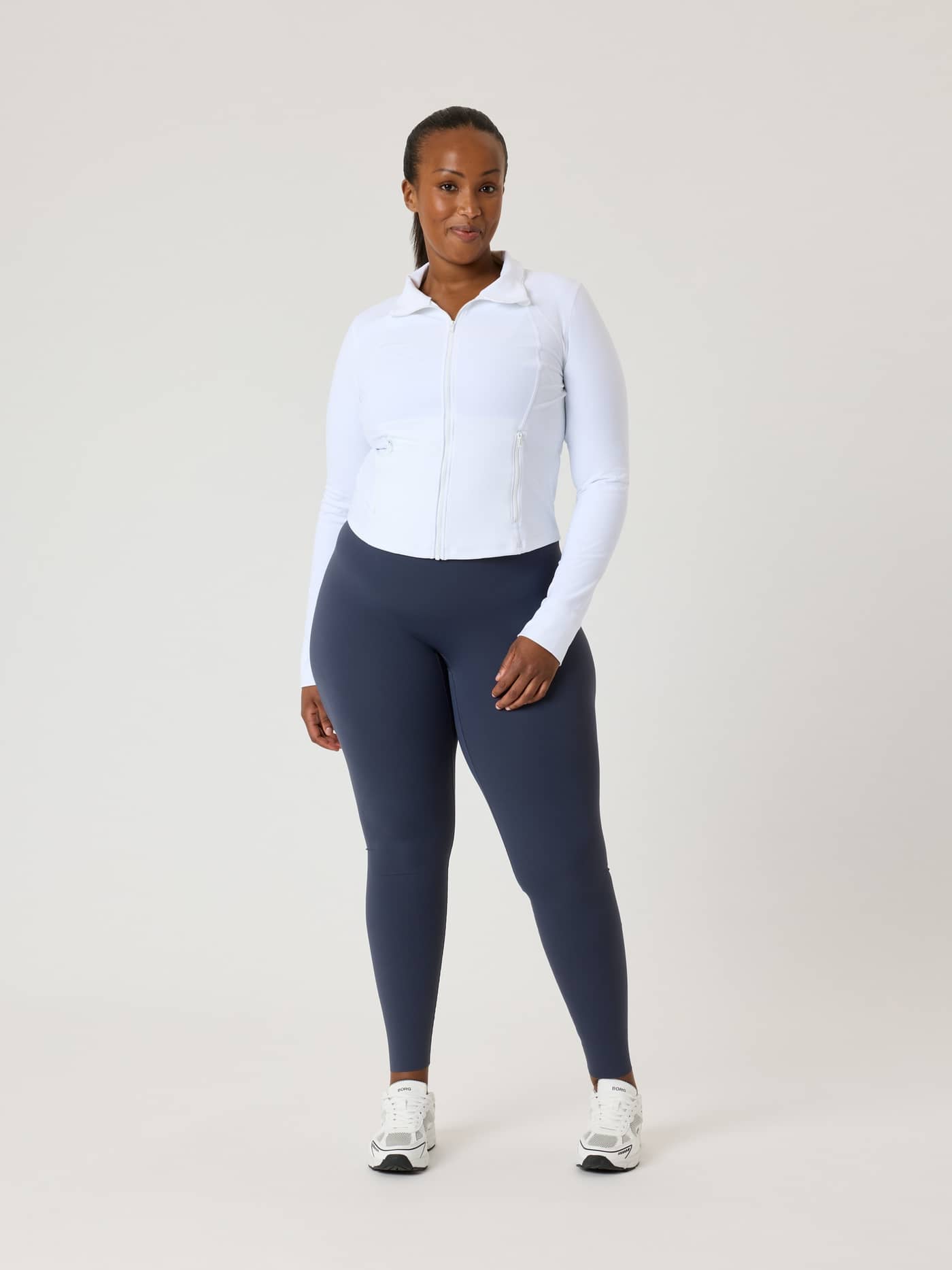 Full-body front view of a model in the slim-fit Alice Stenlöf Soft Zip Midlayer in Brilliant White (White) for training. - Image 13