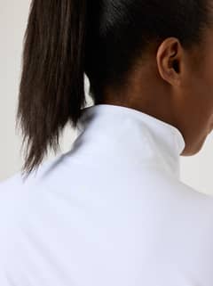 Close-up back view of the training Alice Stenlöf Soft Zip Midlayer in Brilliant White (White) with a small white logo. - Image 14
