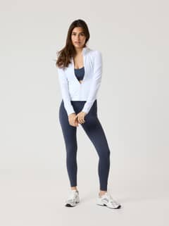 Front view of a woman in the slim fit Björn Borg Alice Stenlöf Soft Zip Midlayer in Brilliant White (White) for training. - Image 10