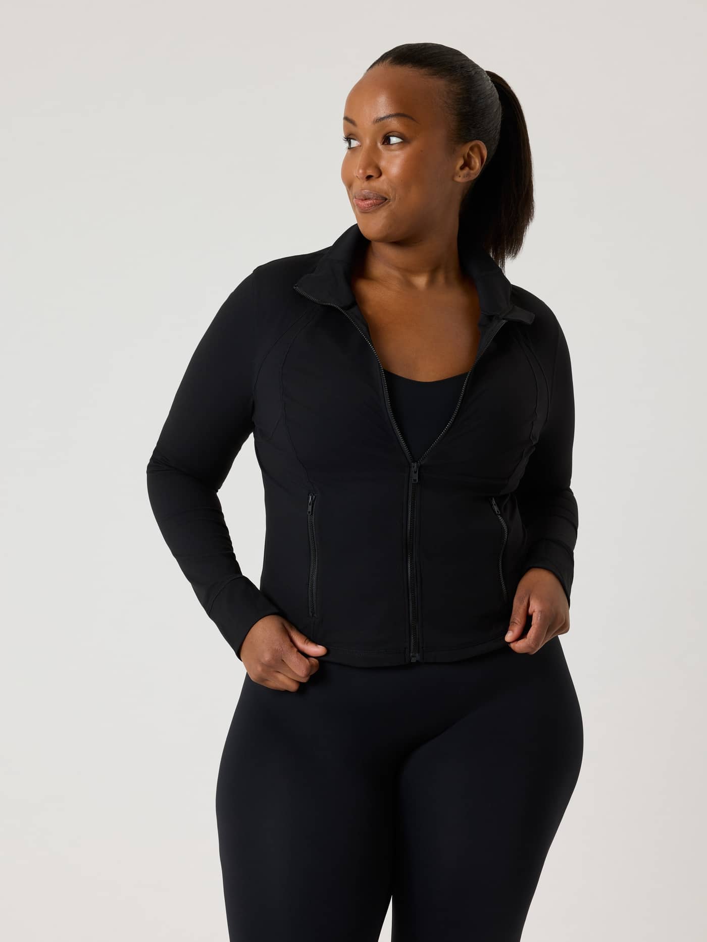 Front view of a model wearing the slim fit Alice Stenlöf Soft Zip Midlayer in Black Beauty (Black) for training. - Image 5
