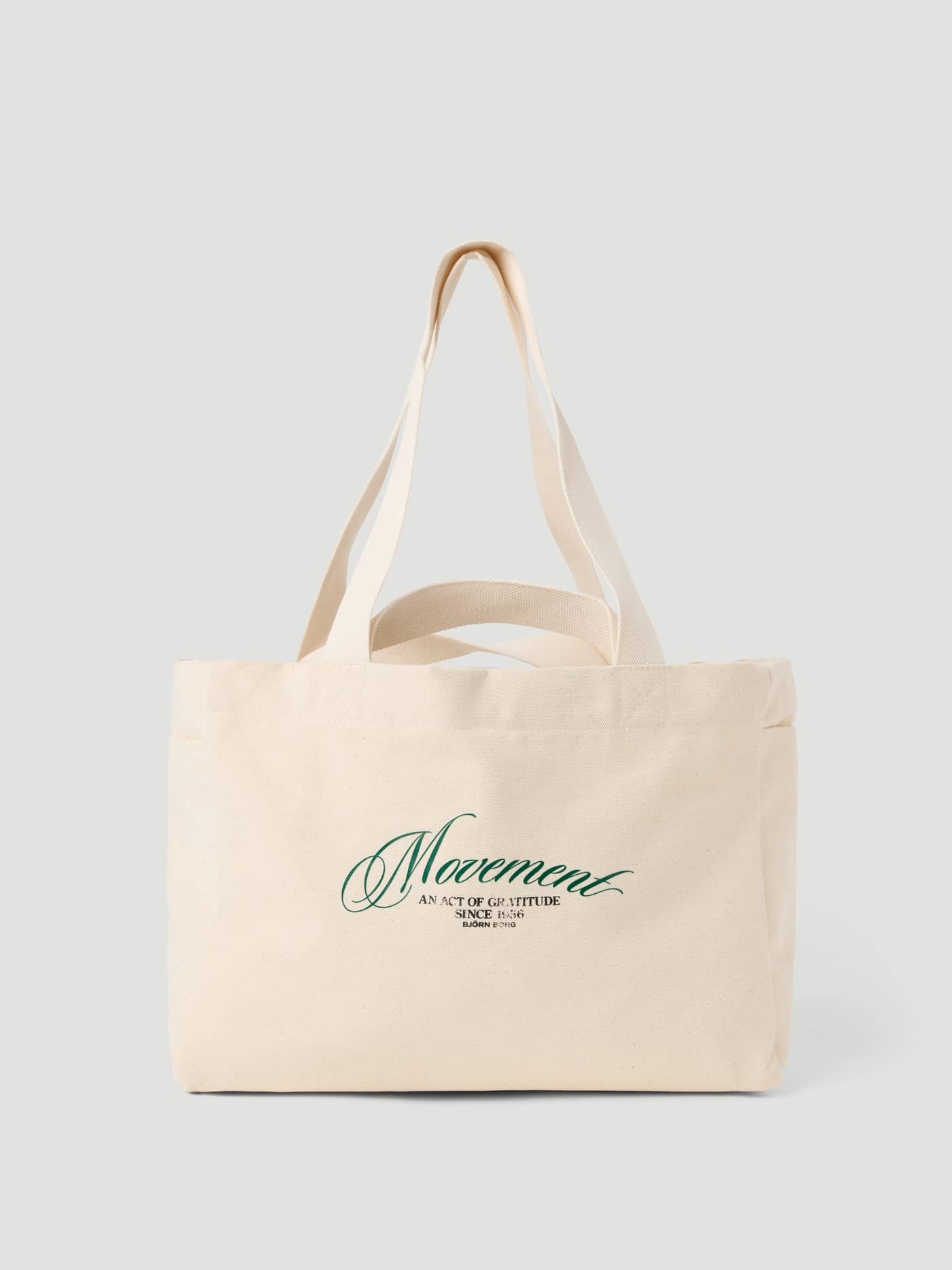 Vue de face du Alice Stenlöf Canvas Tote 24L en Egret (Blanc) en toile de coton avec plusieurs anses et imprimé vert. - Image 1