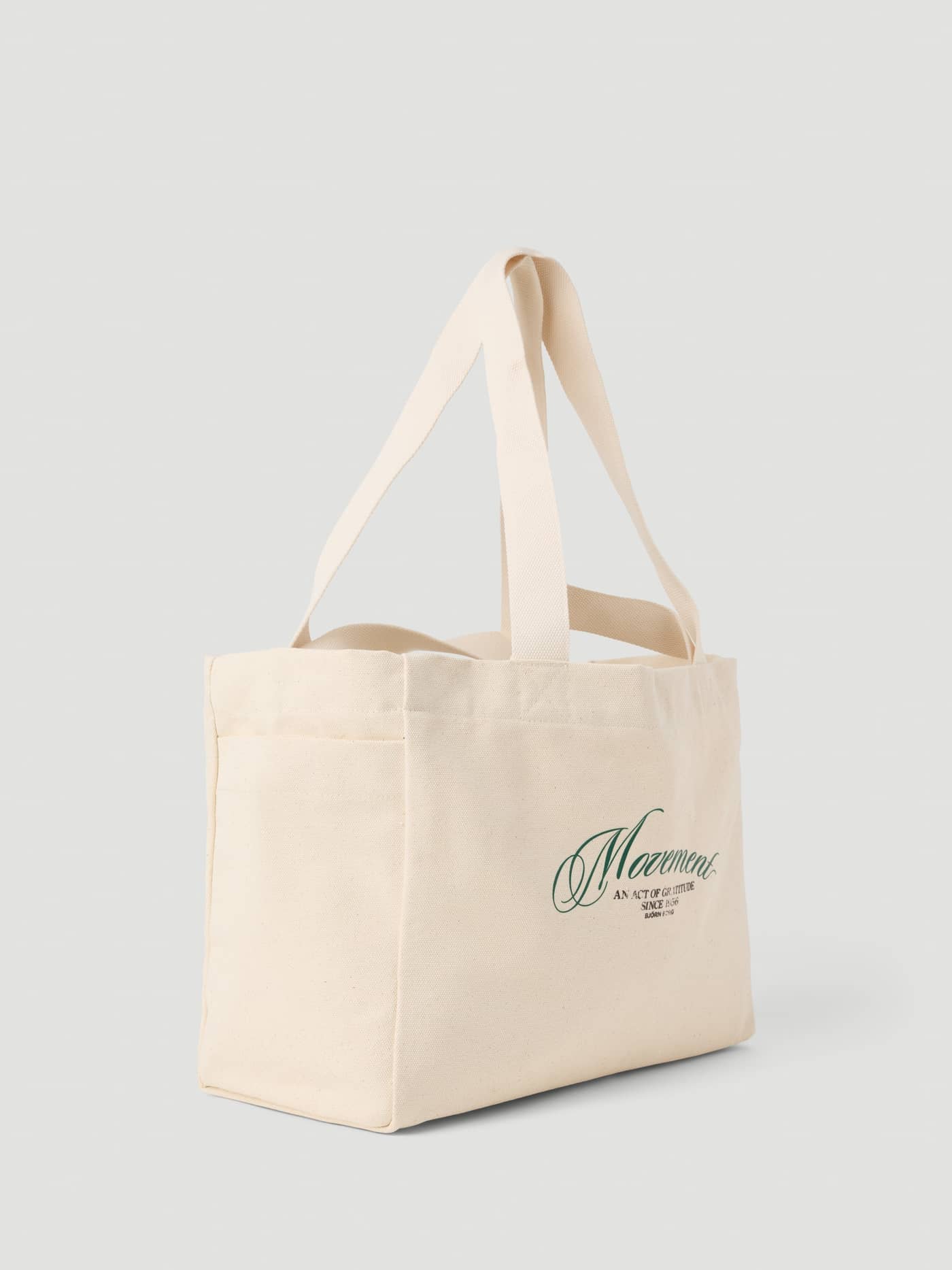 Alice Stenlöf Canvas Tote 24L in Egret (White), crafted from durable cotton canvas with a green graphic Movement print. - Image 3