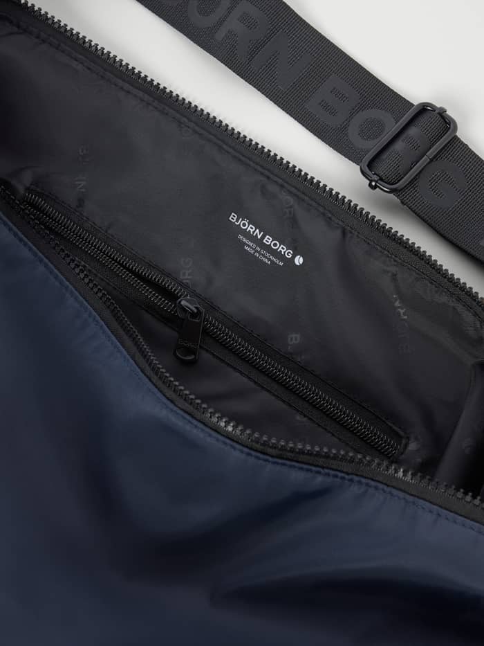Close-up of the Odyssey Gray (Blue) Borg Classic Shoulder Bag 13L for training with a white logo and recycled polyester. - Image 3