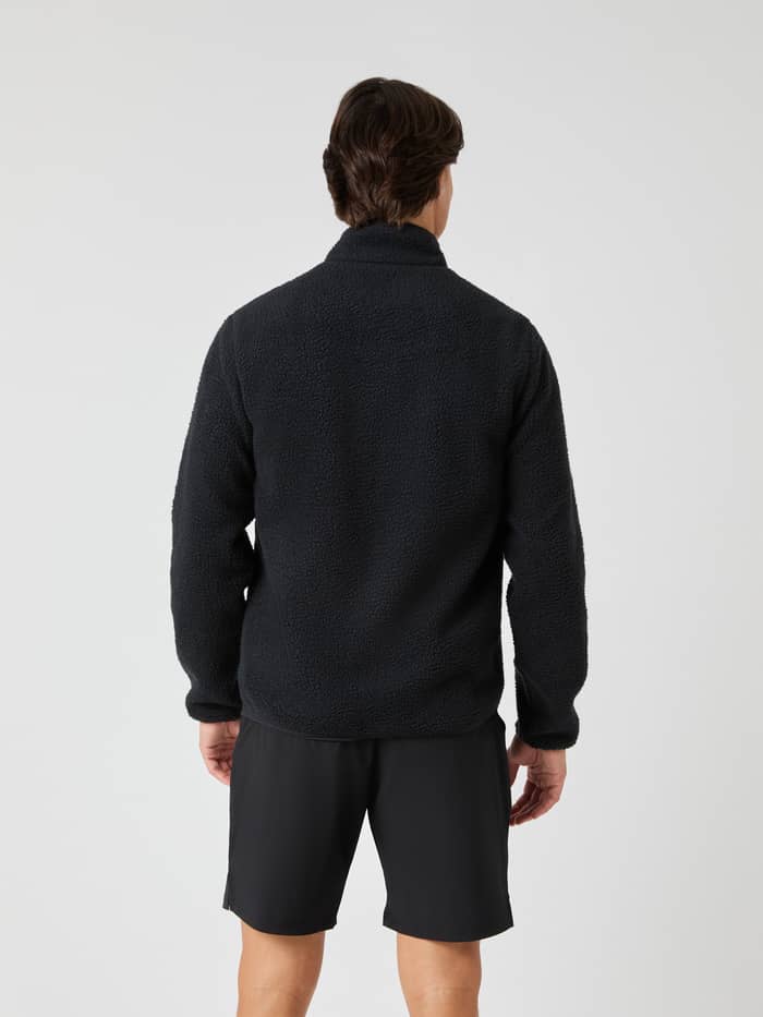 Back view of a man wearing the functional Björn Borg Centre Pile Jacket in Black Beauty (Black) with a soft texture. - Image 2