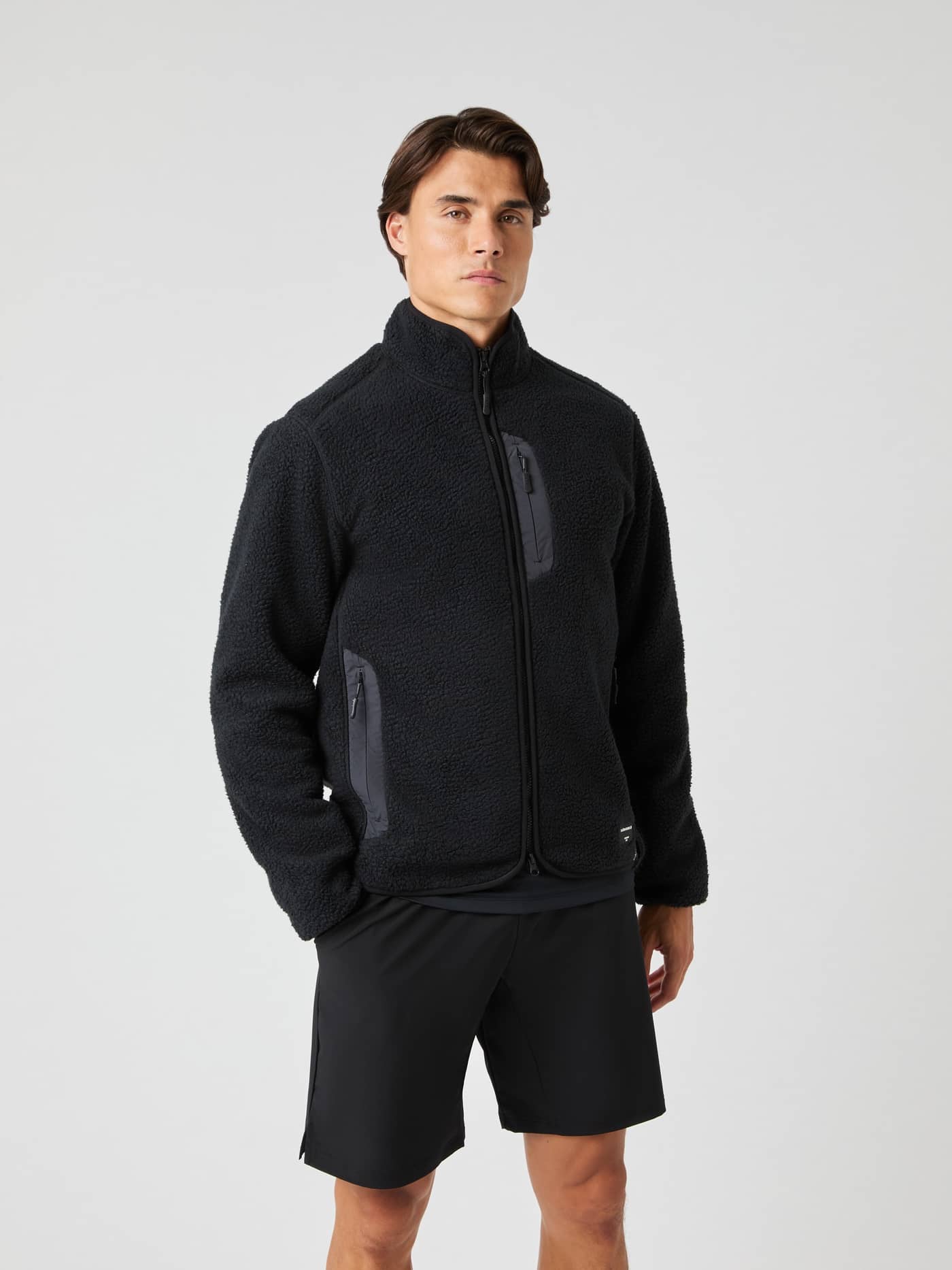 Front view of a man wearing the Björn Borg Centre Pile Jacket in Black Beauty (Black) for functional style. - Image 1