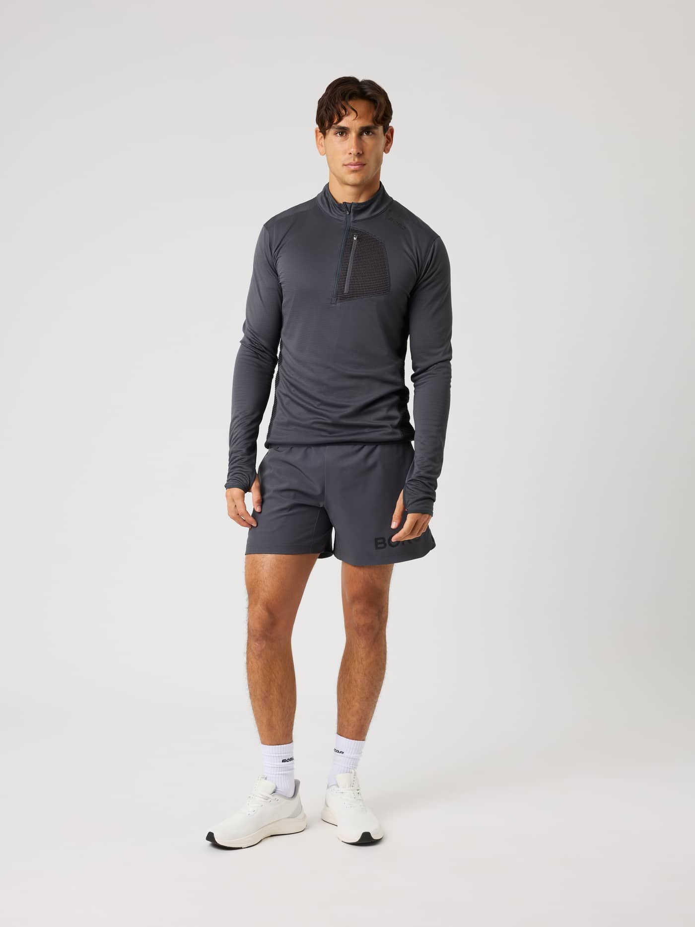Full-body view of a model wearing the Borg Fleece Midlayer in Asphalt (Black) for training, featuring a half-zip front. - Image 4