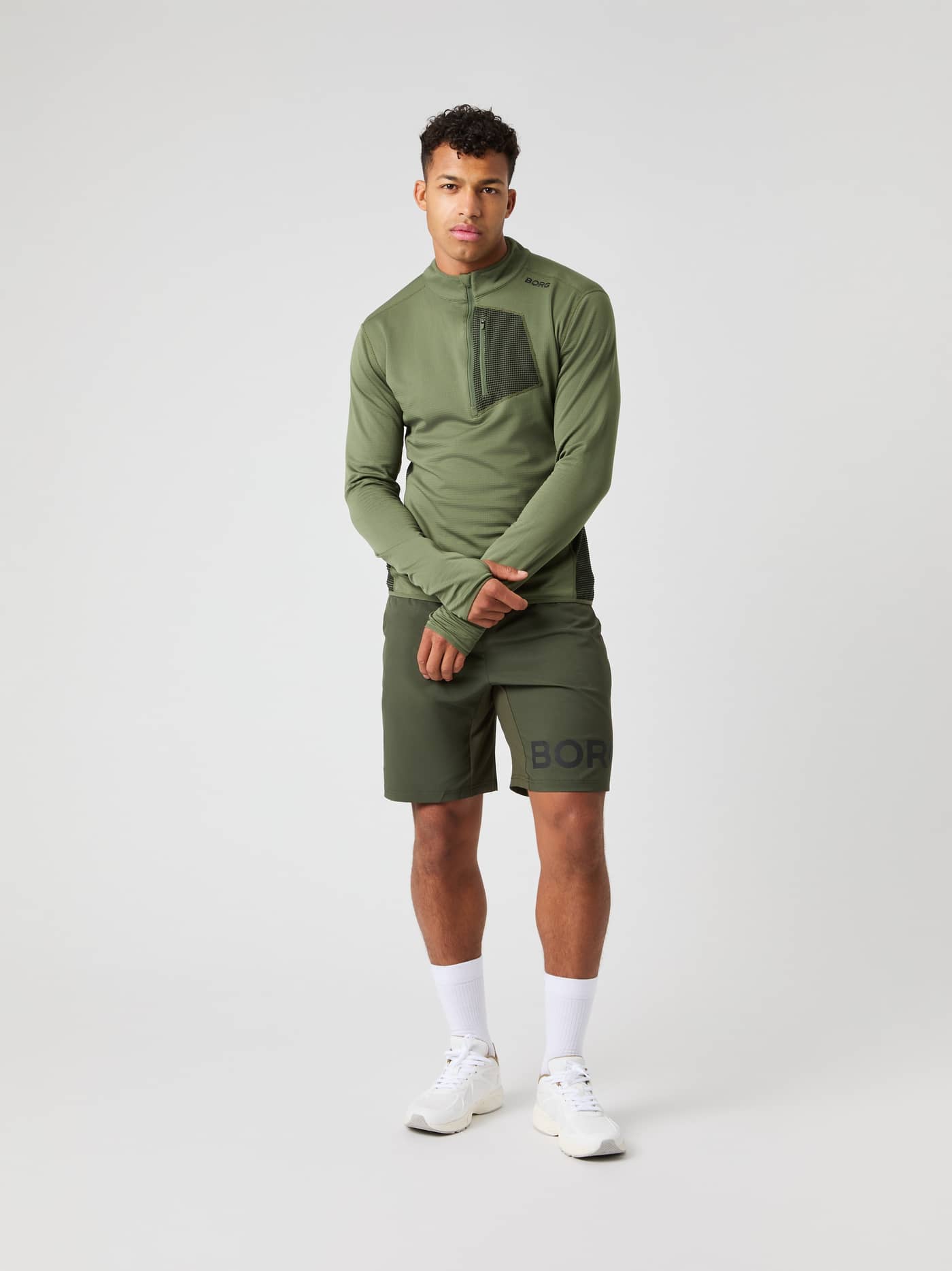 Vue en pied d'un homme portant le Borg Fleece Midlayer en Forest Night (Vert) avec logo noir pour l'entraînement. - Image 3