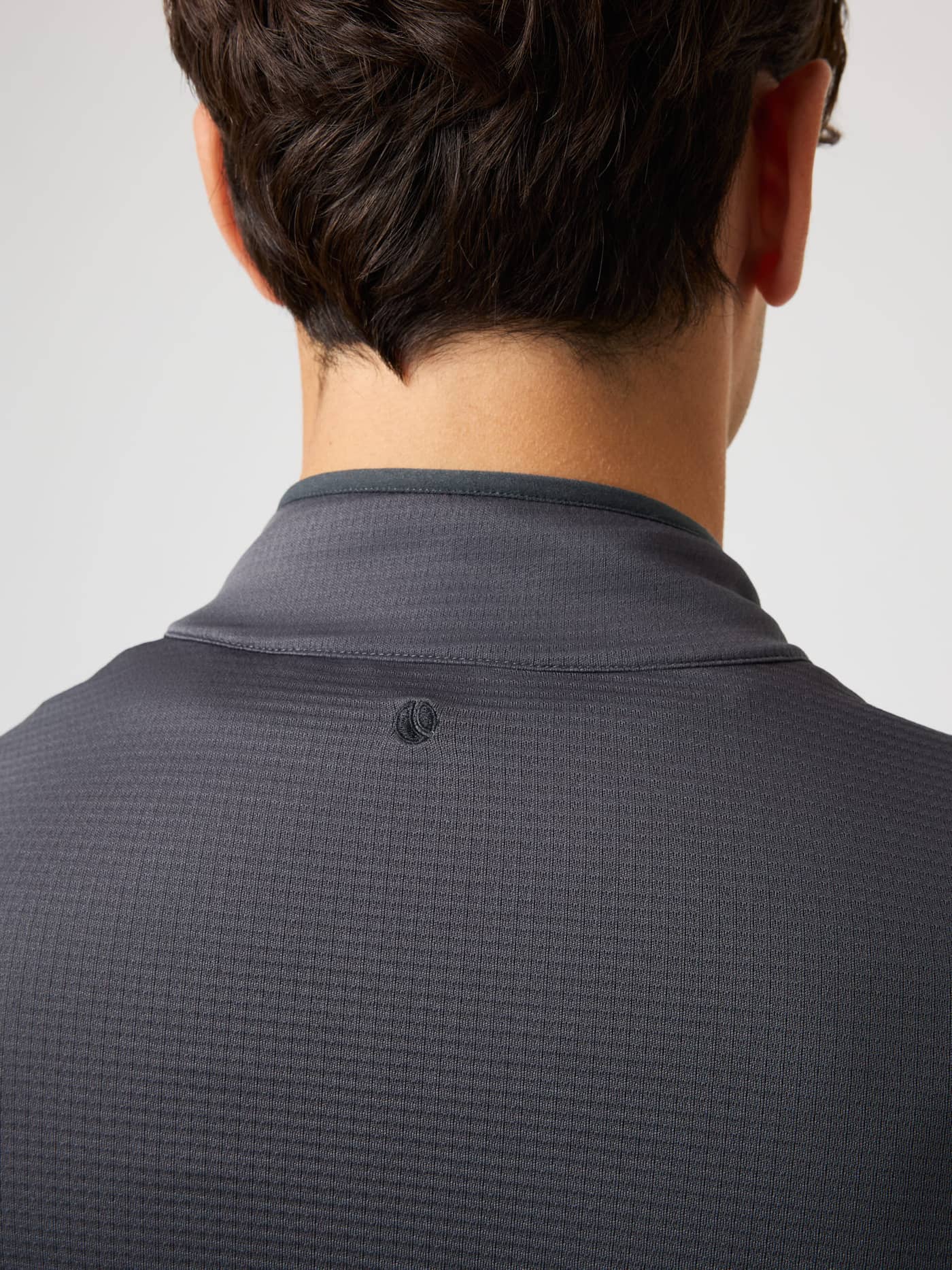Close-up back view of the Borg Fleece Midlayer in Asphalt (Black) for training, with waffle fleece and a tonal tennis logo. - Image 5