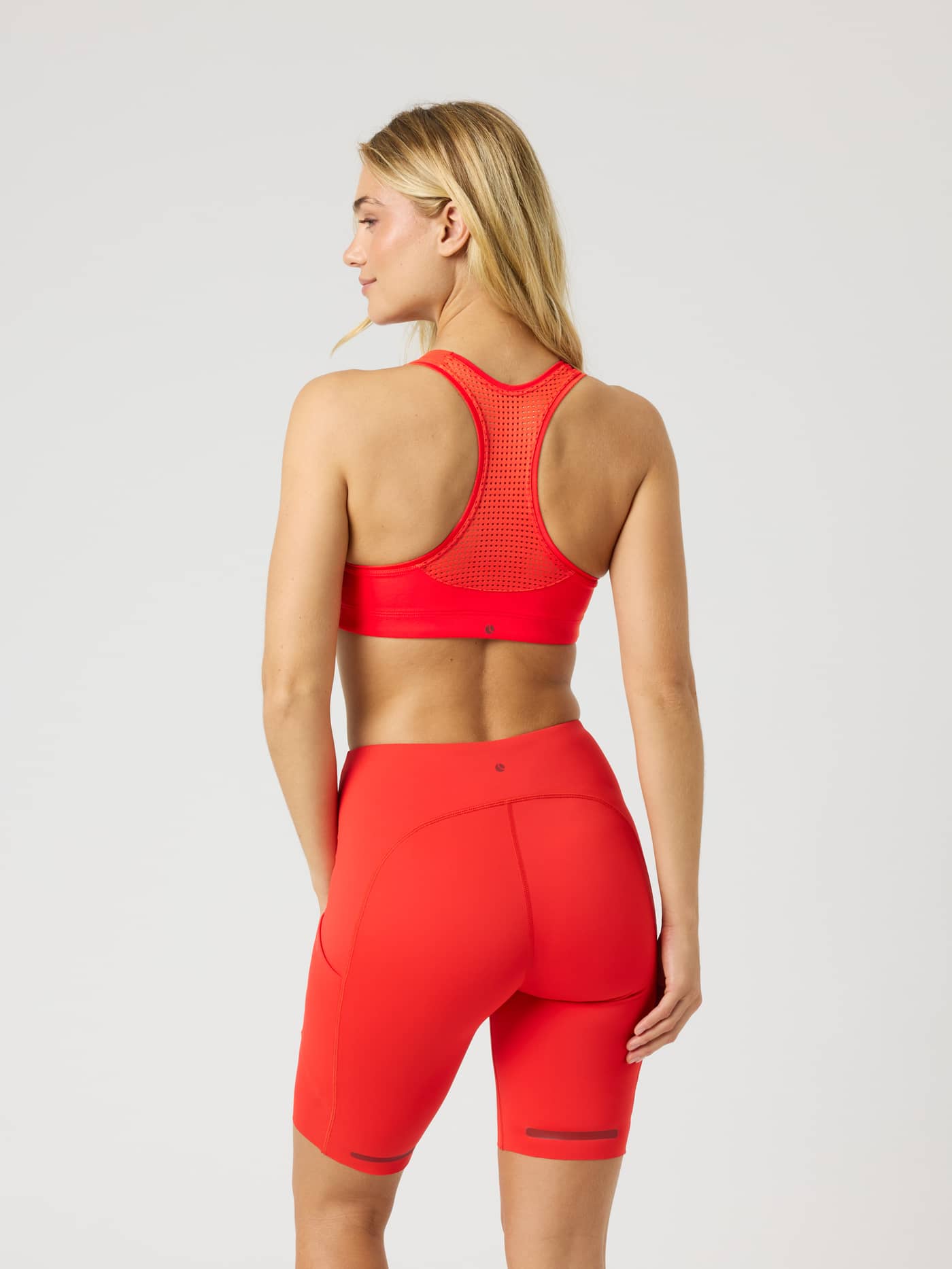 Back view of the Borg Mid Support Sports Bra in Flame Scarlet (Red) with a breathable mesh racerback, ideal for training. - Image 2