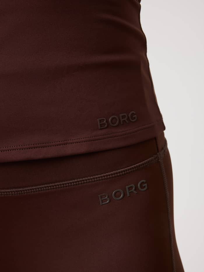 Close-up of the Borg Soft Racerback Tank Top in Coffee Bean (Brown) with a tonal logo, designed for training. - Image 4