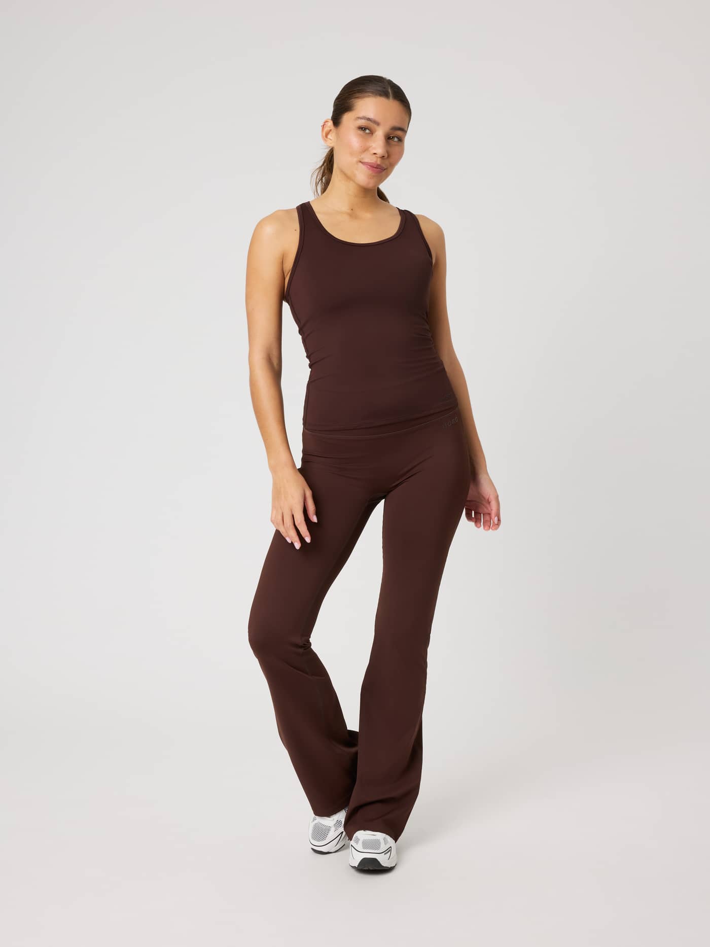 Full-body front view of a model wearing the Borg Soft Racerback Tank Top in Coffee Bean (Brown) for training. - Image 3
