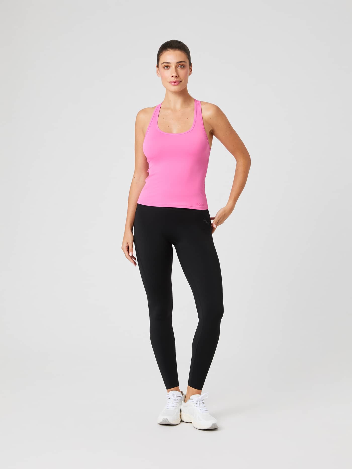 Full-body front view of a model wearing the training Borg Soft Racerback Tank Top in Ibis Rose (Pink) with a slim fit. - Image 3