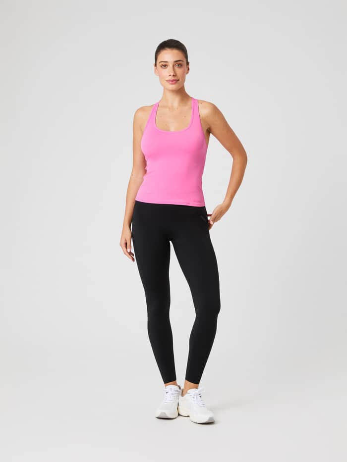 Full-body front view of a model wearing the training Borg Soft Racerback Tank Top in Ibis Rose (Pink) with a slim fit. - Image 3