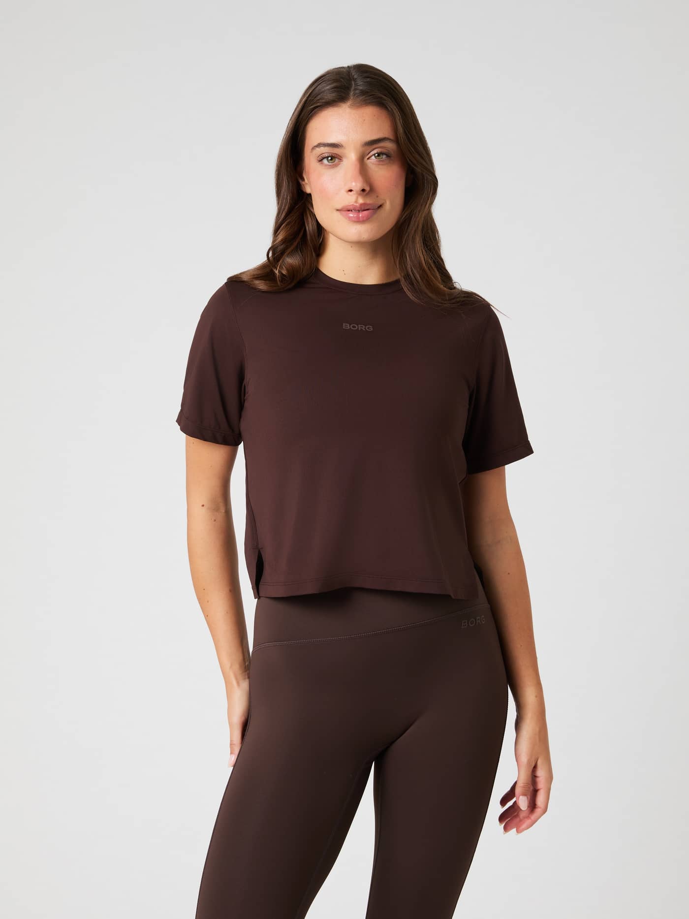 Front view of a model wearing the brown Borg Cropped T-shirt and matching leggings. - Image 1