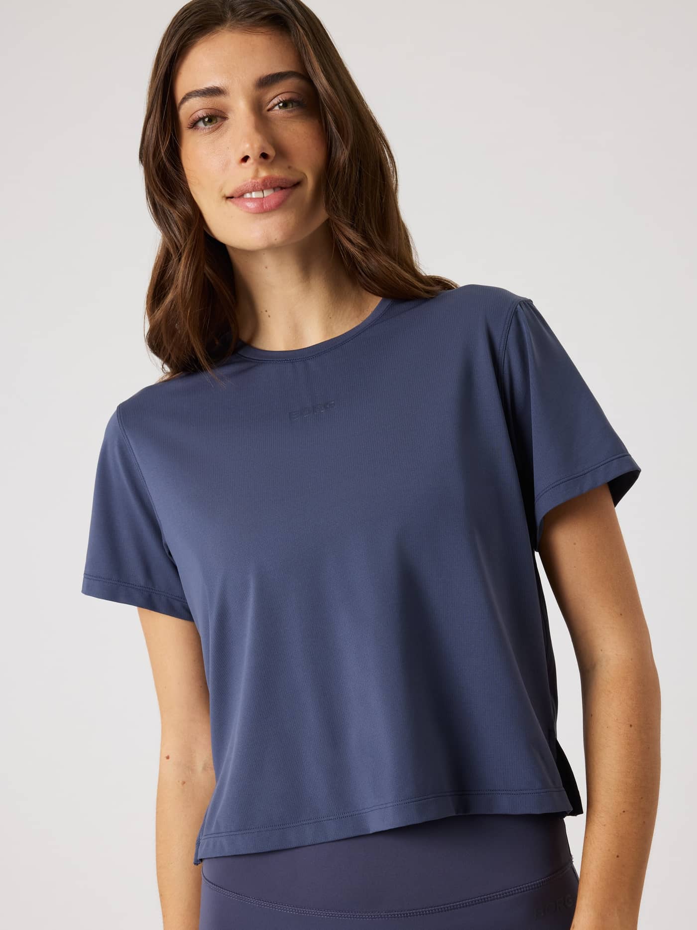 Front view of a woman wearing the Odyssey Gray (Navy) Borg Cropped T-Shirt, a stylish and breathable training top. - Image 4