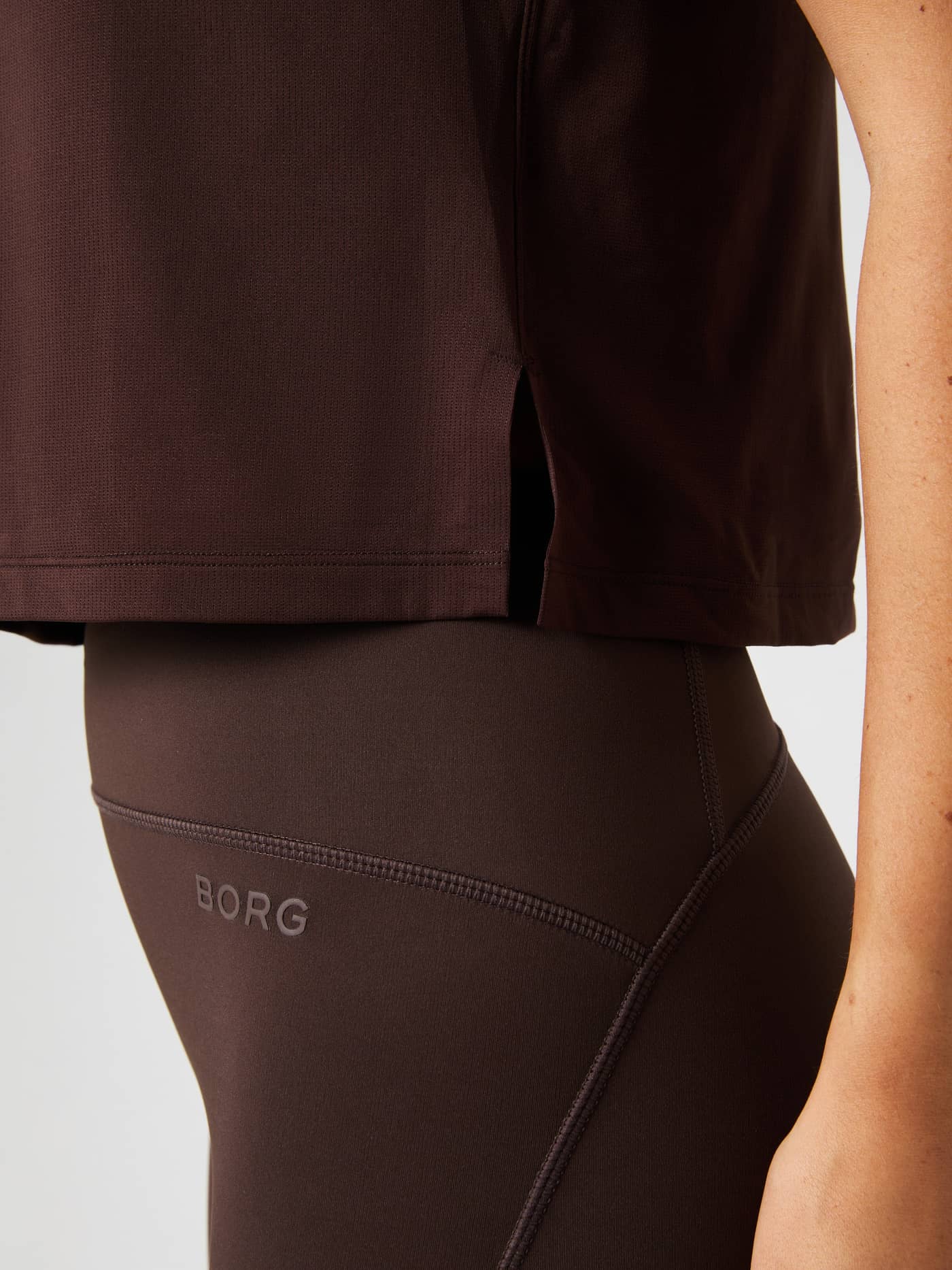 Detailed shot of the side seam slit on the brown Borg Cropped T-Shirt. - Image 6