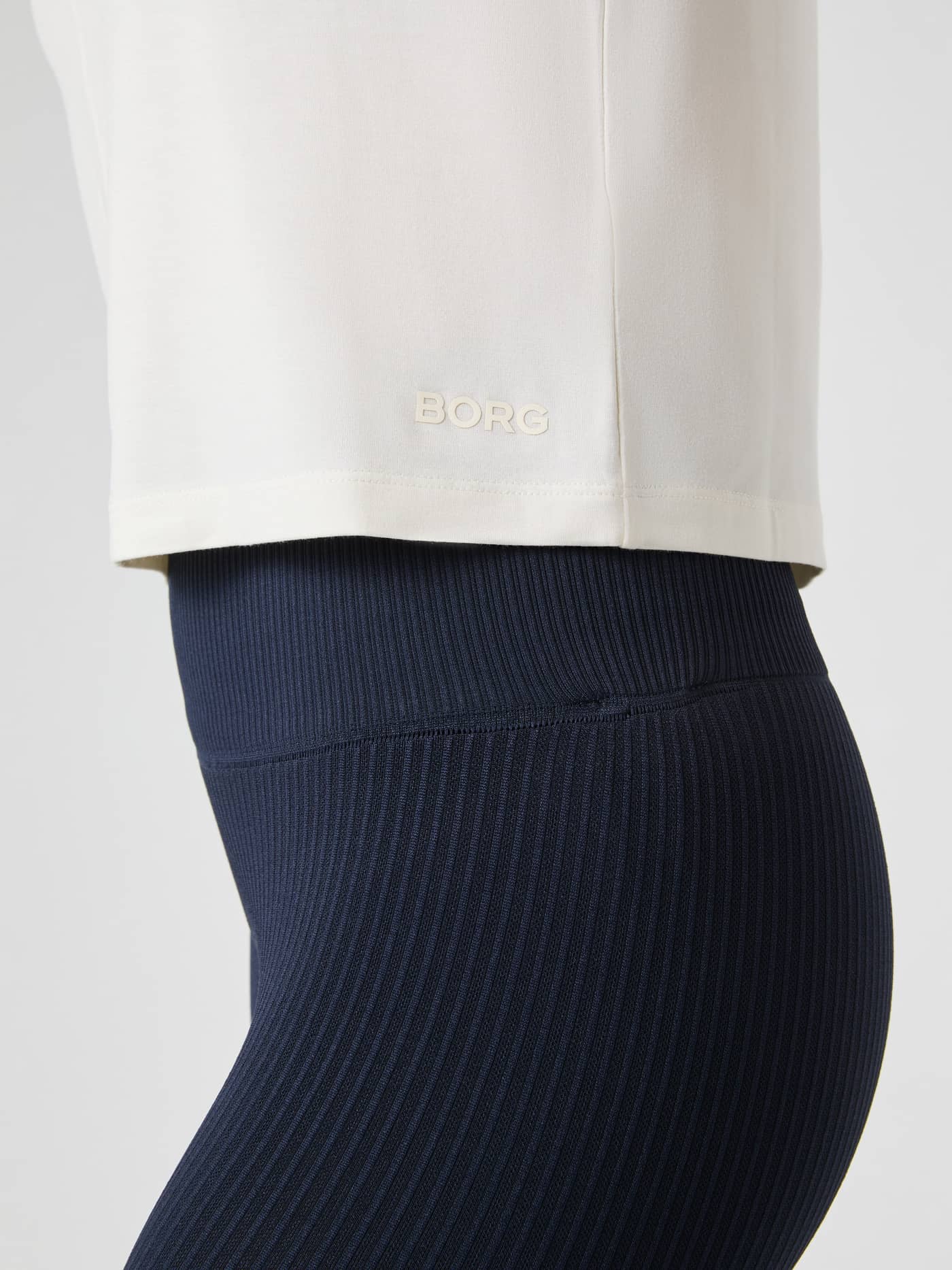 Side view of the Studio Soft T-Shirt in Tofu (White) with a tonal BORG logo and flexible performance fit for training. - Image 5
