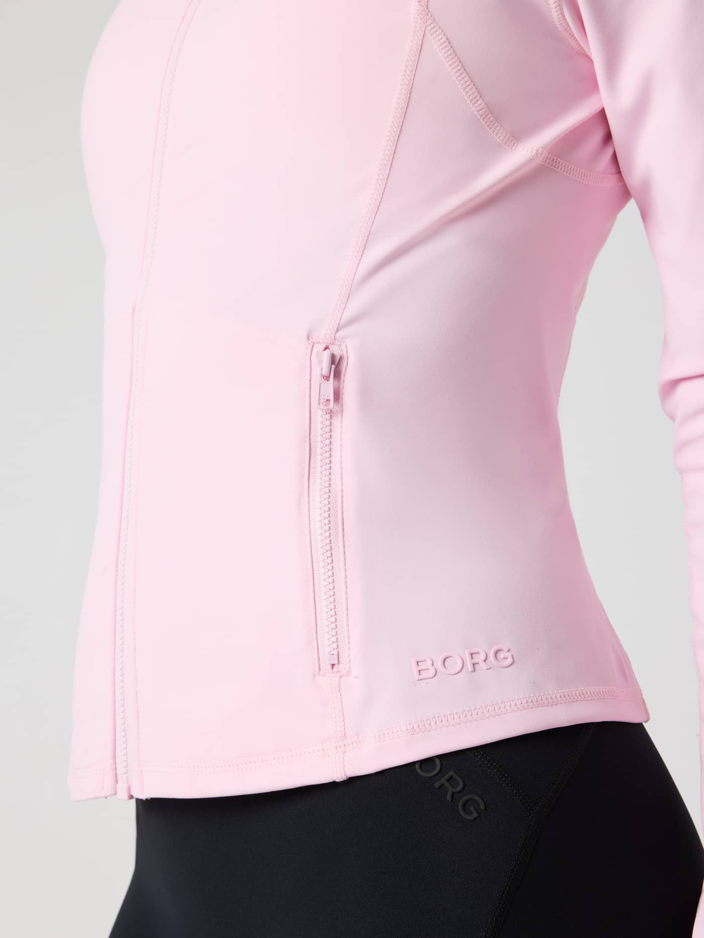 Detailed close-up of the training Borg Soft Zip Midlayer in Pink Lady (Pink) with a flattering fit and pink BORG logo. - Image 7