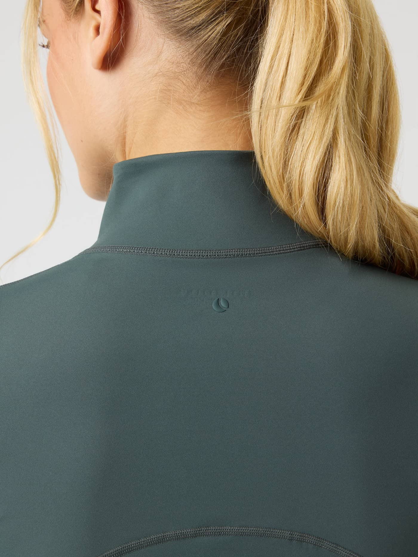 Close-up back view of the Borg Soft Zip Midlayer in Urban Chic (Green) showing the mock neck and tonal logo for training. - Image 4