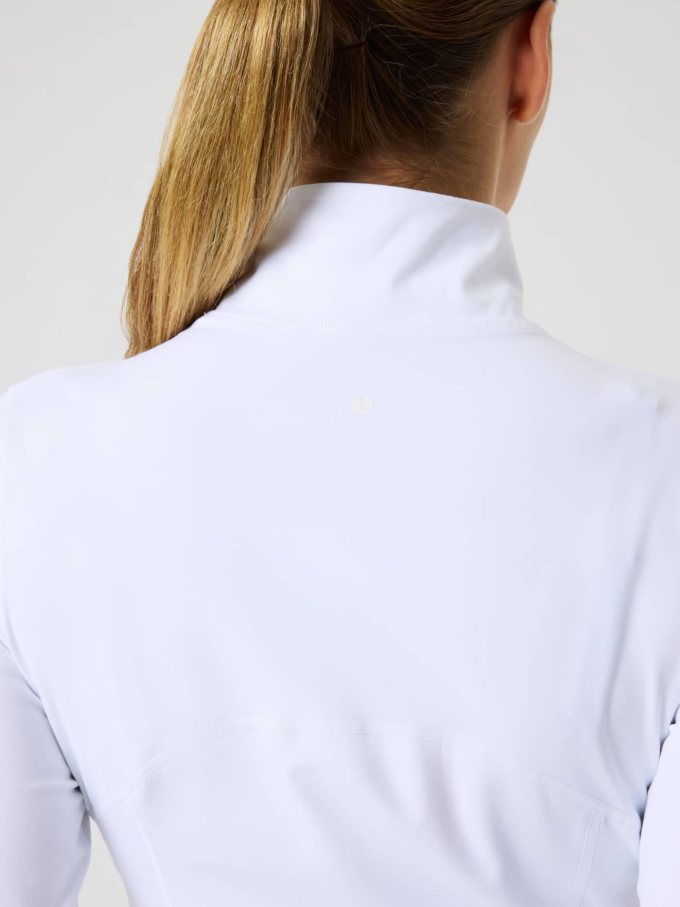 Close-up back view of the training Borg Soft Zip Midlayer in Brilliant White (White), featuring a mock neck and white logo. - Image 5
