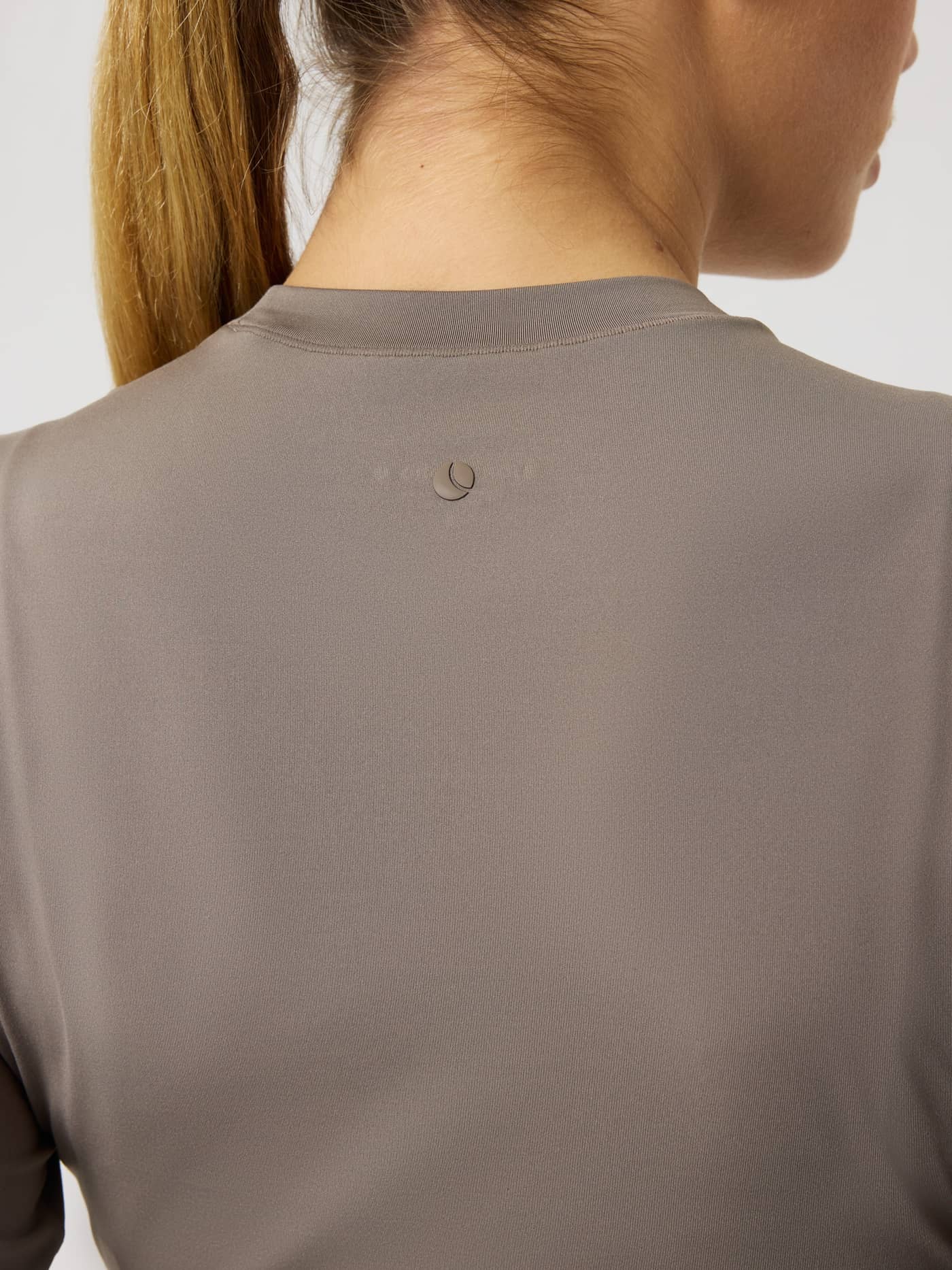Vue arrière détaillée du Studio Soft Cropped Longsleeve en Falcon (Brun) avec un petit logo ton sur ton pour l'entraînement. - Image 4
