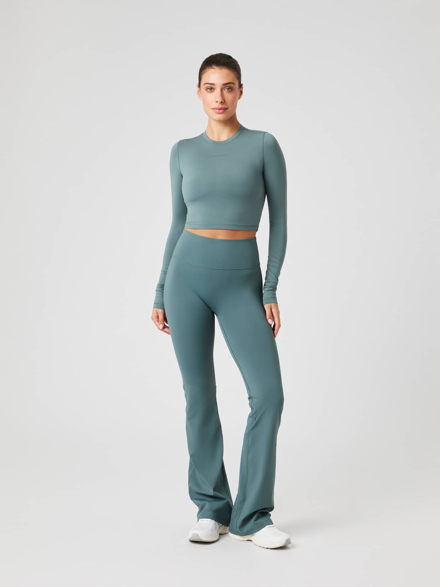 Studio Soft Cropped Longsleeve in Balsam Green (Groen) met flared leggings voor training, getoond in vooraanzicht. - Image 2