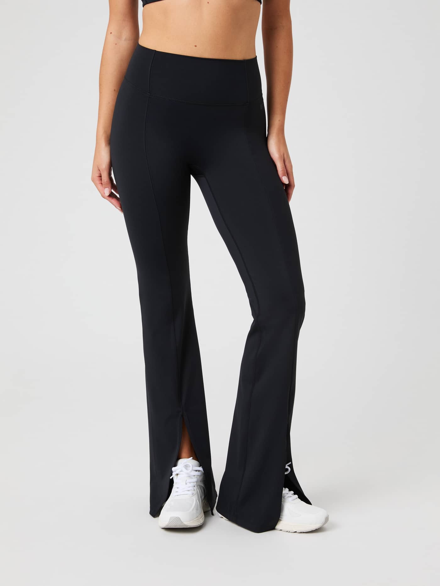 Front view of a model in Black Beauty (Black) Studio Flared Slit Tights for training, with a high waist and front slits. - Image 3