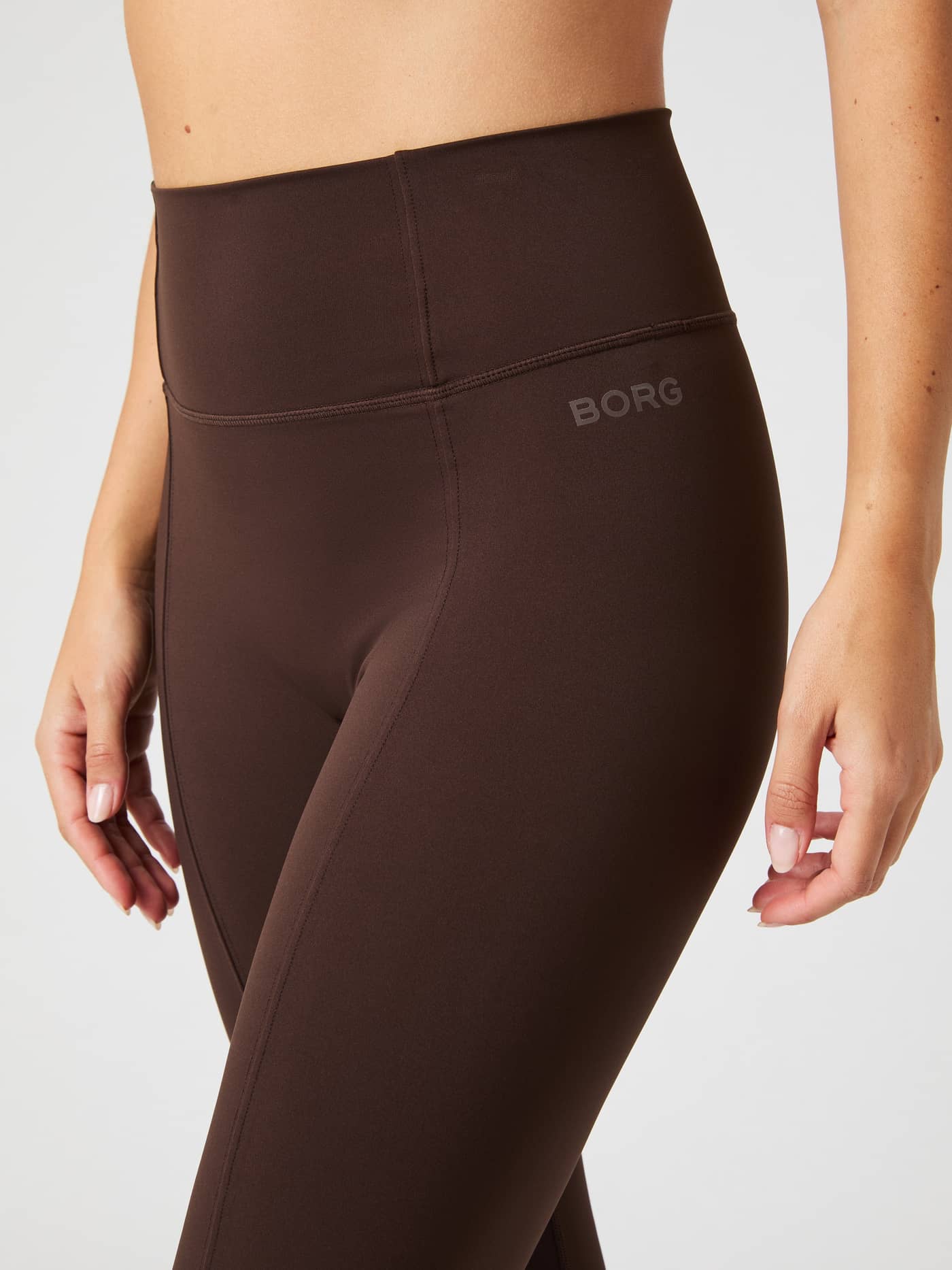Studio Flared Slit Tights in Molé (Brown) for women, showcasing decorative seams and a tonal logo for a stylish training fit. - Image 5